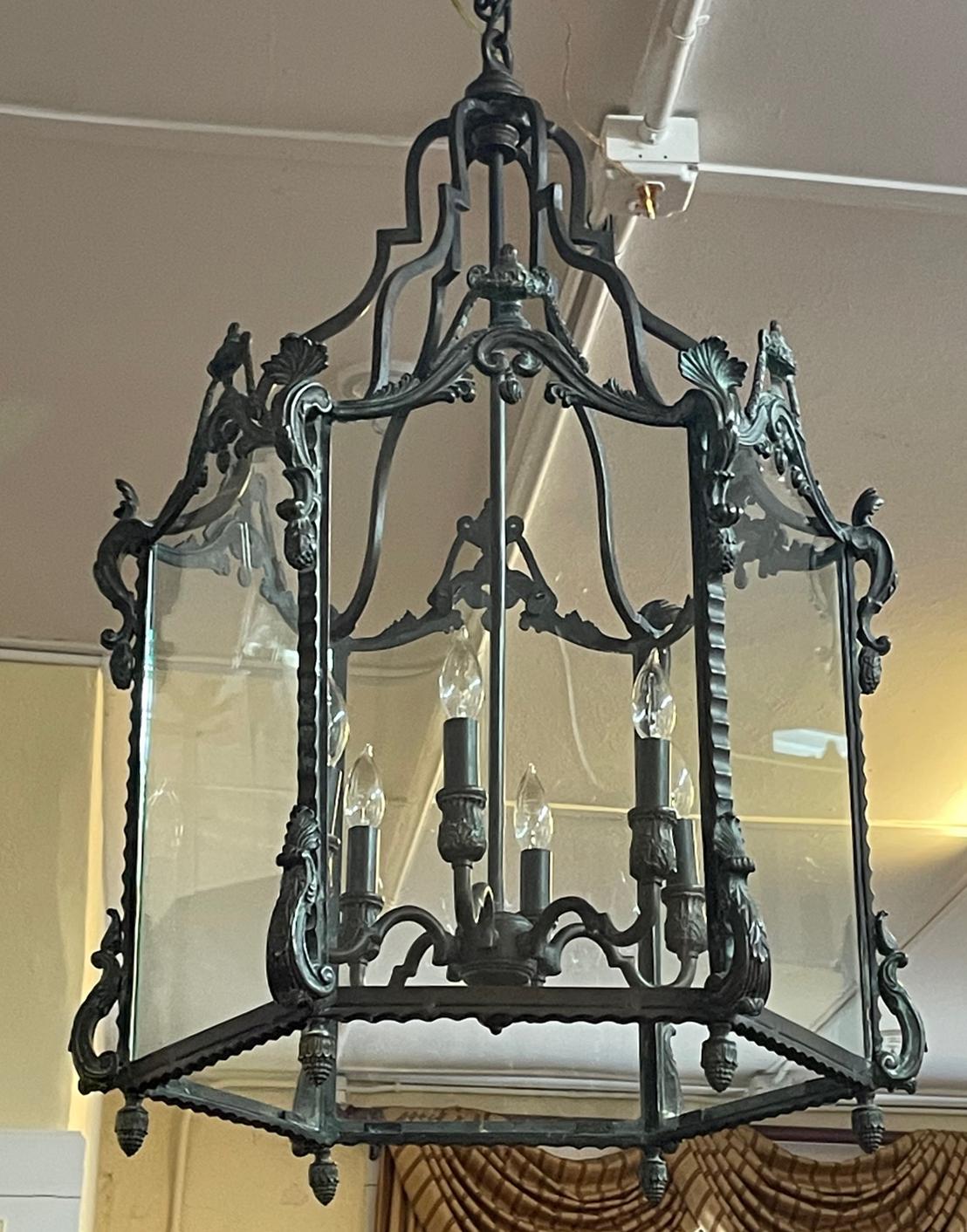 Gorgeous High Quality Bronze Patina 6 Light Chandelier Lantern 38 X 24 X 24

Dimensions : 38 X 24 X 24

This lantern has a gorgeous bronze patina and is well cast! The lantern is in good vintage condition some scratches to the glass but are not