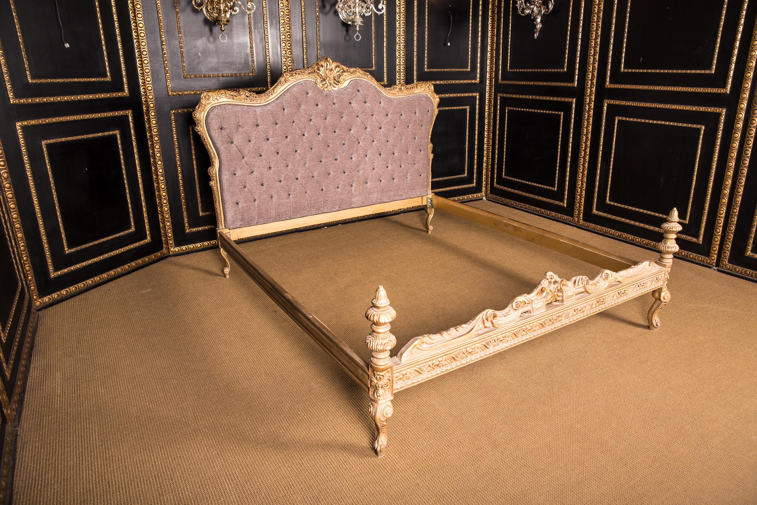 Solid beechwood, finely carved, colored and gilt gilded. Low foot and high headboard quilted, curved backrest frame and open rocaille crowning. Everything is done by hand.