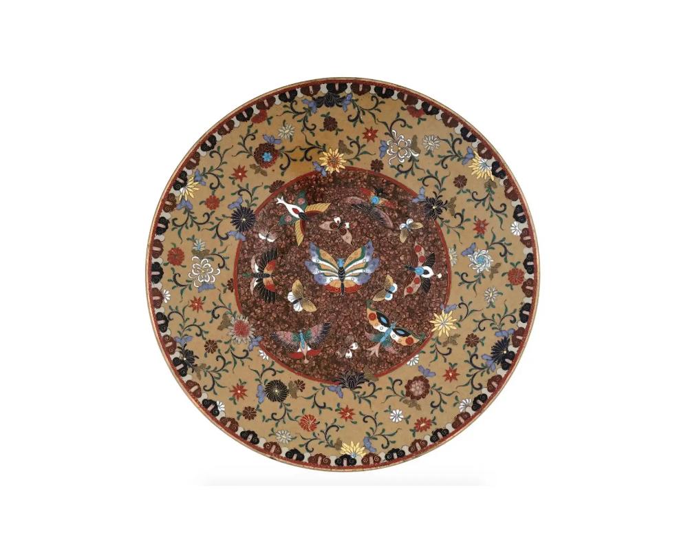High Quality Antique Meiji Japanese Cloisonne Enamel Gold Stone Charger Plate Butterflies

A high quality Japanese, enamel charger or plate. The plate is adorned with polychrome images of butterflies in the center, surrounded by floral and foliage