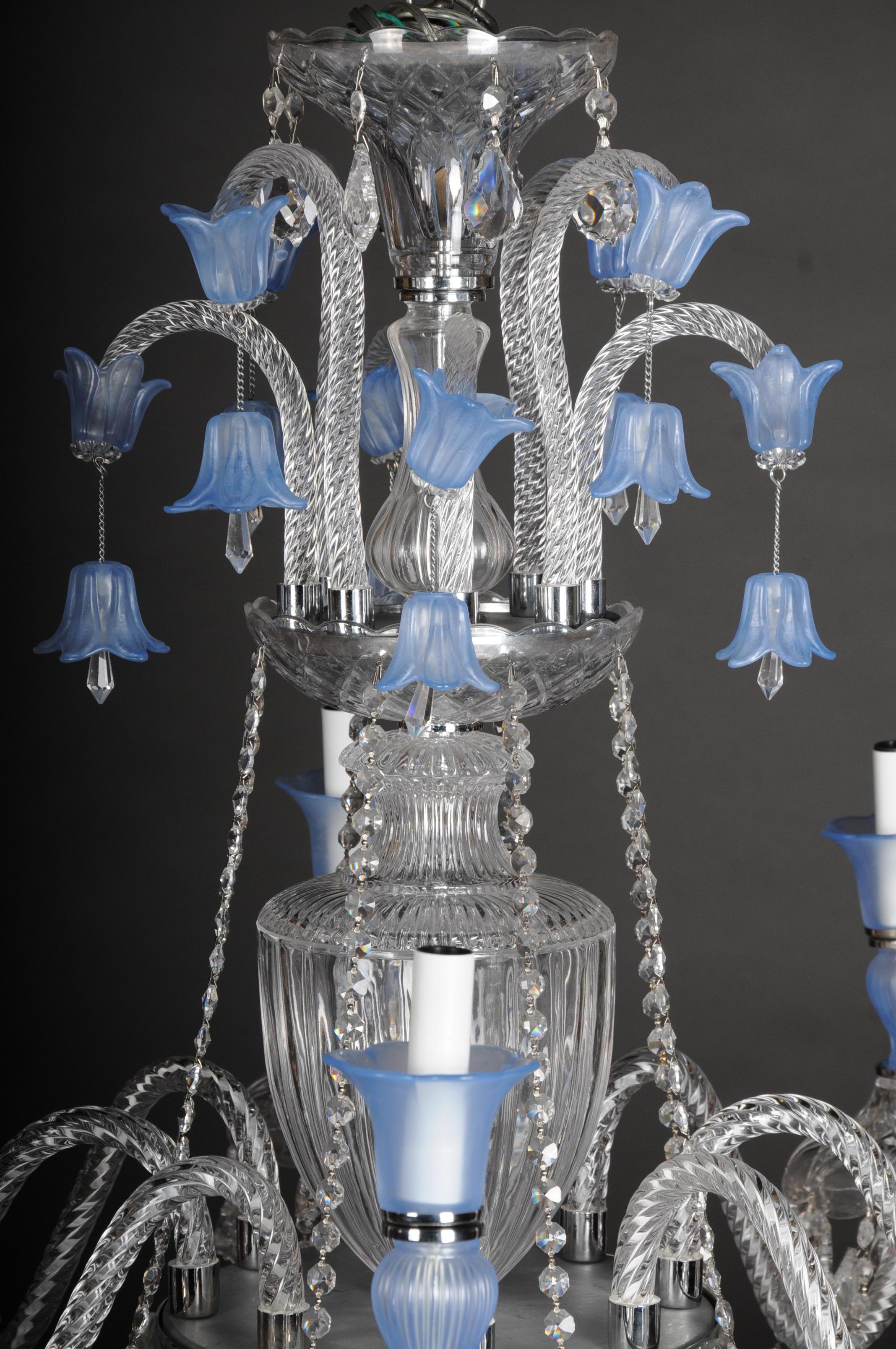 High quality large crystal chandelier, probably Murano

Modern high quality chandelier probably Murano. 8 arms. In the center, multi-articulated baluster-shaped glass shaft with crowning. 8 external flames. The finely cut crystals, which contain