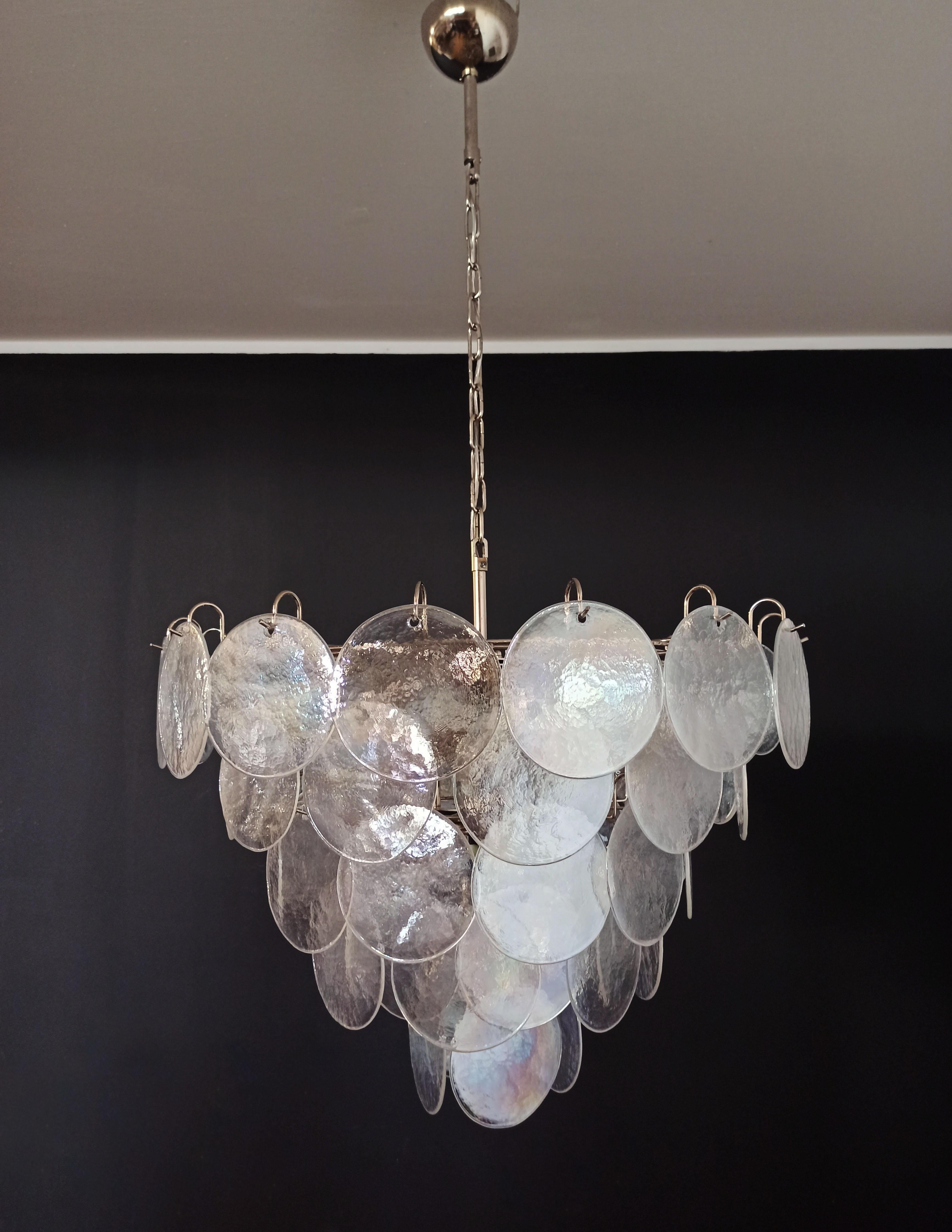 Italian Murano chandelier. The chandelier has 57 Murano iridescent glass disks. The glasses are now 
unavailable, they have the particularity of reflecting a multiplicity of colors, which makes the chandelier a true work of art. Nickel metal