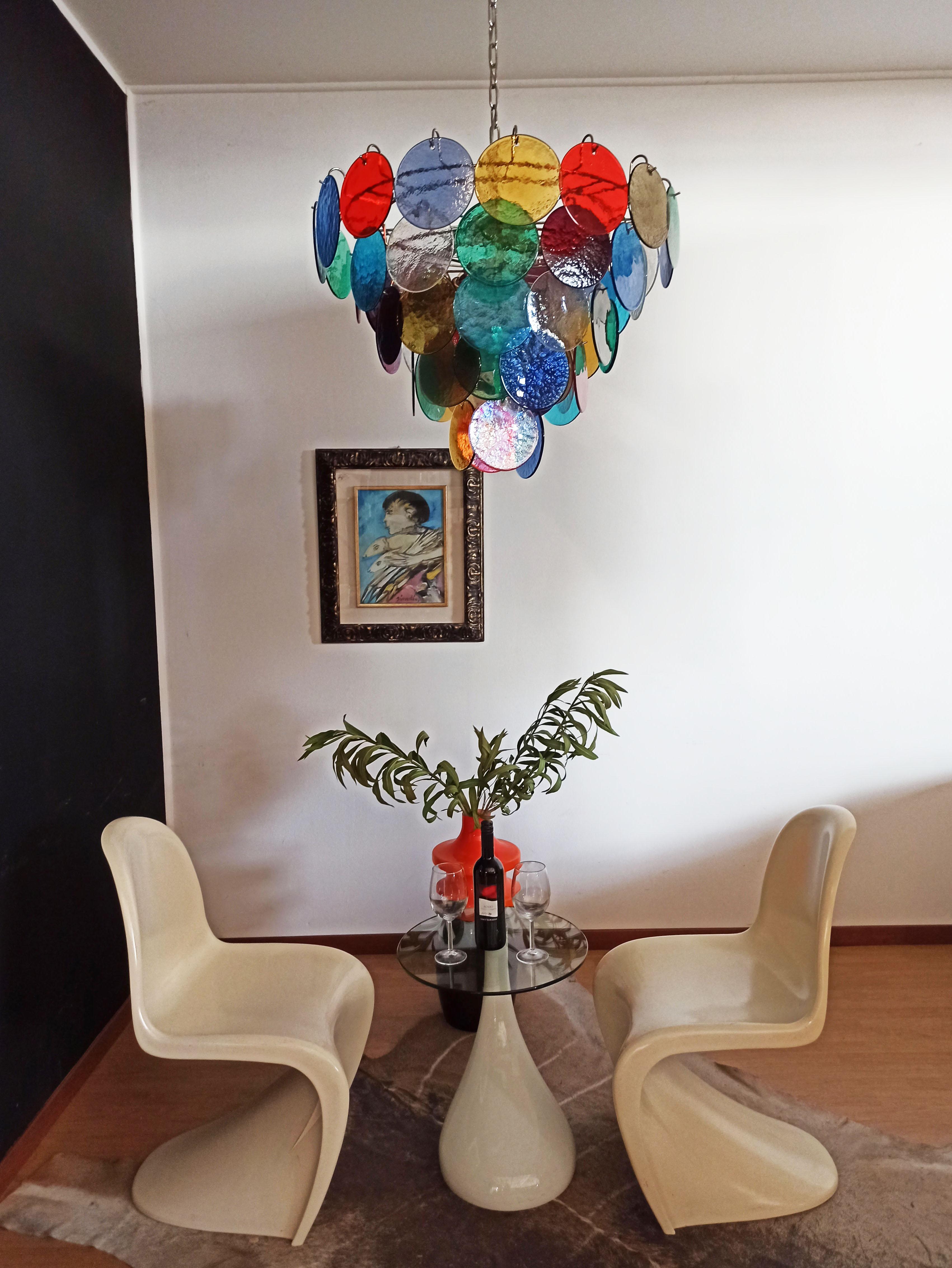 Italian Murano chandelier. The chandelier has 57 Murano multicolored glass disks. Nickel metal frame.
Period: 1980'S
Dimensions: 48.80 inches (126 cm) height with chain, 25.60 inches (65 cm) height without chain, about 27.50 inches (70 cm)