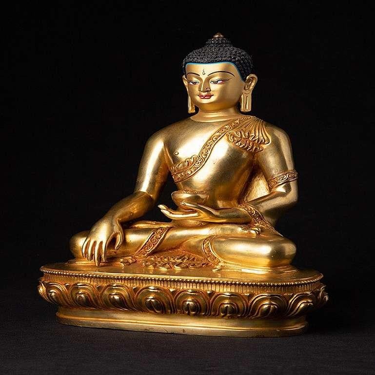 Material: bronze
Measures: 27, 8 cm high 
21 cm wide and 13, 2 cm deep.
Weight: 3.540 kgs.
Fire gilded with 24 krt. gold.
Bhumisparsha mudra.
Originating from Nepal.
Newly made in the highest quality.
The face is gold painted.
 