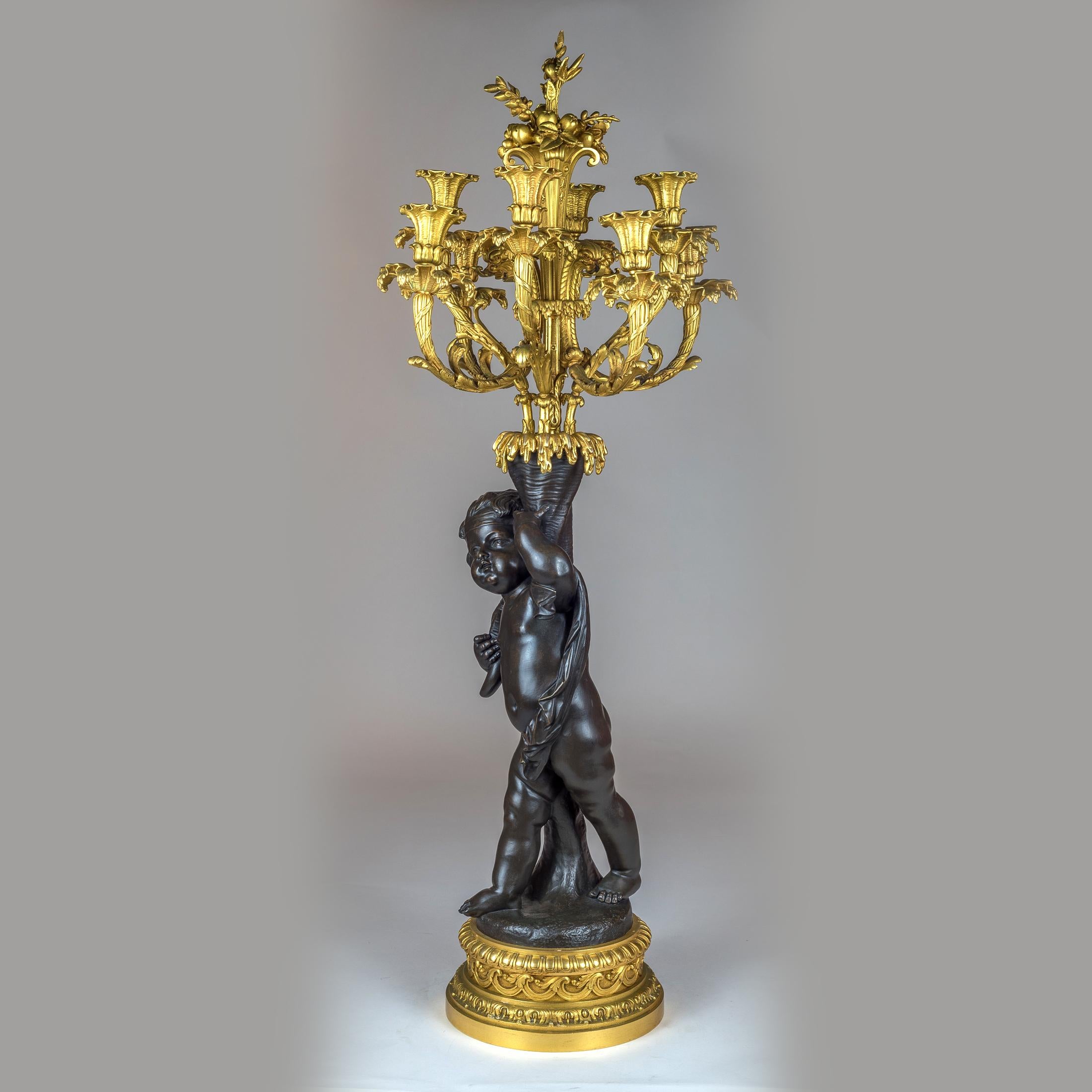 A high quality pair of patinated and gilt bronze figural candelabras

Origin: French
Date: 19th century
Dimension: 37 5/8 in. x 17 1/2 in.