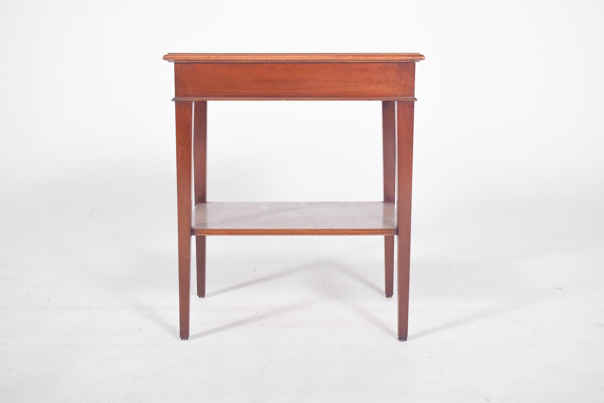 Rectangular side table, tall. Flat top with a slightly protruding upper frame and gently bulging edges, straight square legs with a slight taper towards the base, joined by a rectangular lower shelf positioned at half height, which acts as a