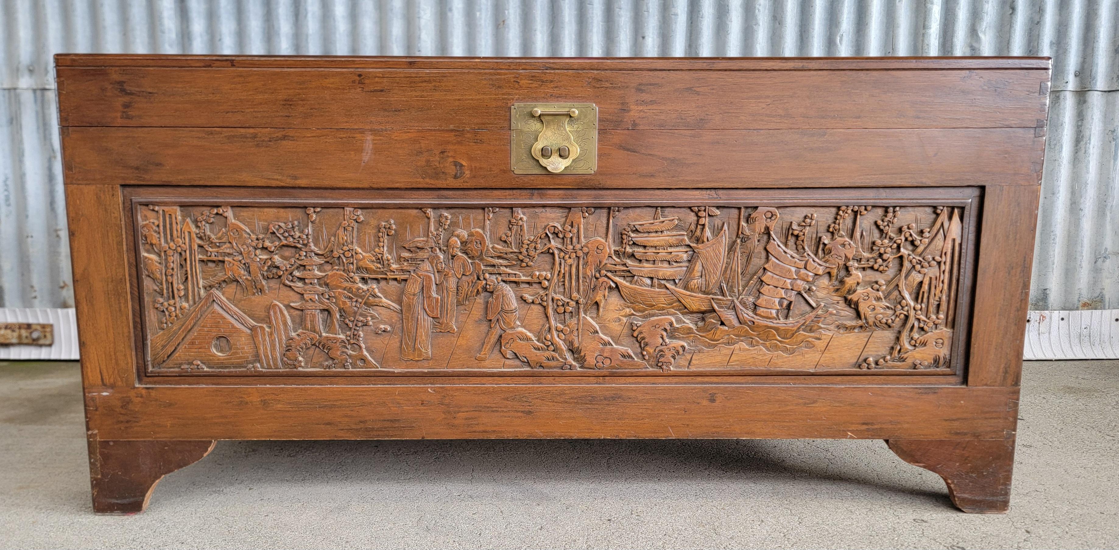 Highly carved camphor wood trunk / hope or blanket chest. Trees, figures and sail boat motif. Very nice original condition and finish. Brass hardware and latch. Small removable tray. Mid 20th Century. 