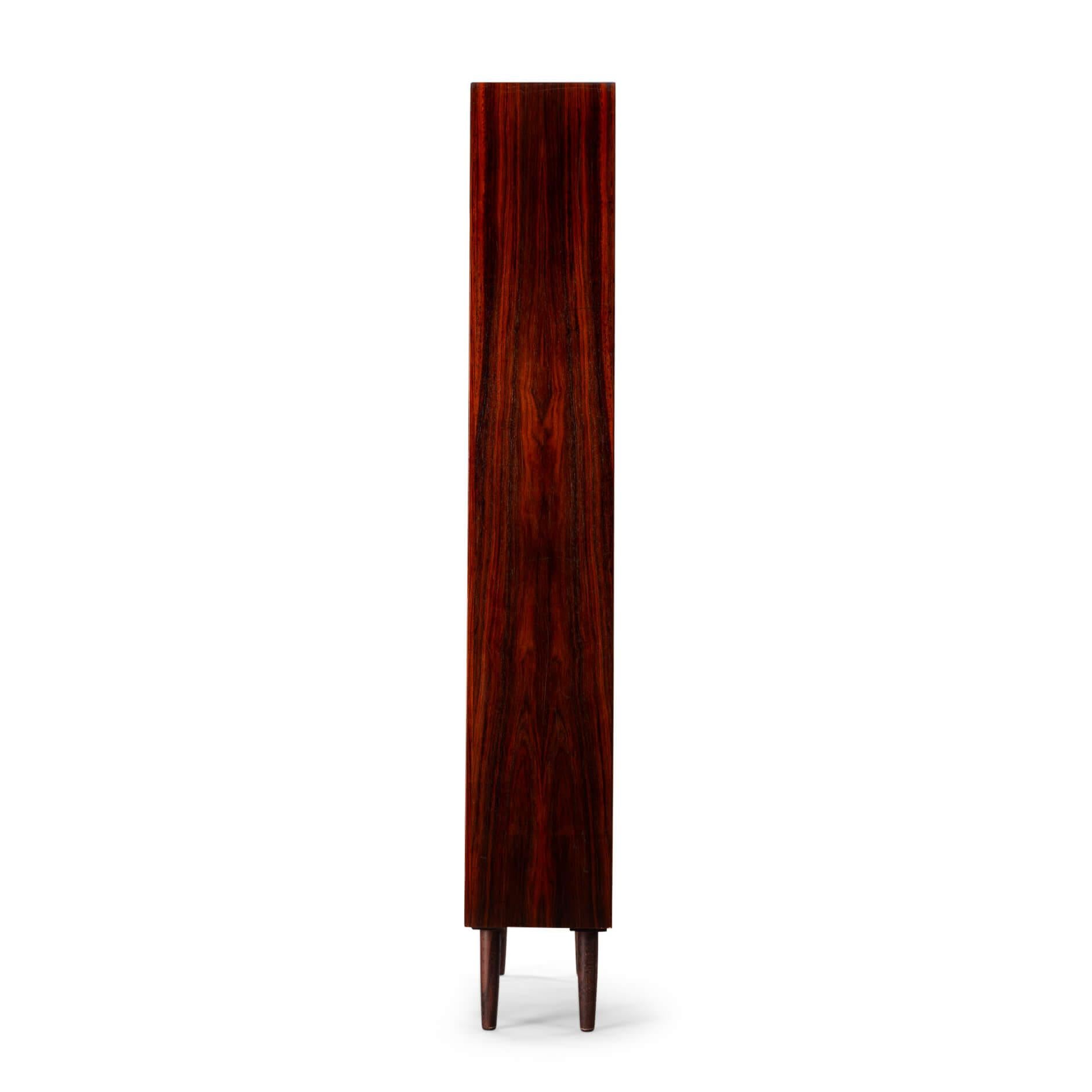 Danish Design
Danish high bookcase in beautiful rosewood veneer by E. Brouer made in his own Brouer Mobelfabrik. Especially this high model is rare nowadays. This bookcase is in very good vintage condition. There are only some scratches on one of