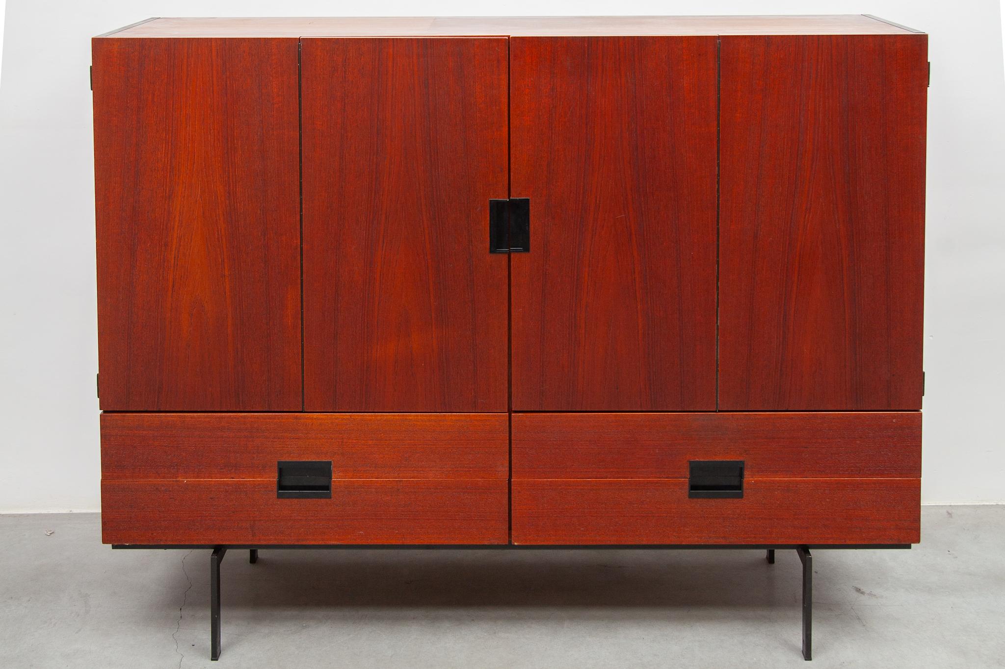 Rare beautiful high sideboard designed by the Dutch designer Cees Braakman for Pastoe, a sideboard from the Japanese series CU 04 made in teak with a warm color. Features with harmonica doors beautifully outlined by the bakelite handles. The cabinet