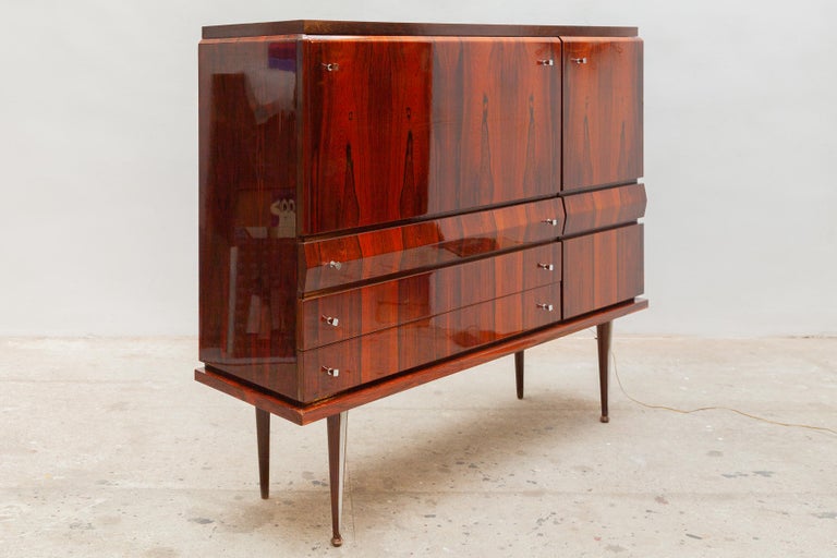 Beautiful high quality of Italian design. Made entirely of precious lines in wood, the furniture is a masterpiece of imperious elegance. 1960's Dry-Bar in style of Paolo Buffa. High gloss madagascar veneer with an exclusive interior with red accents