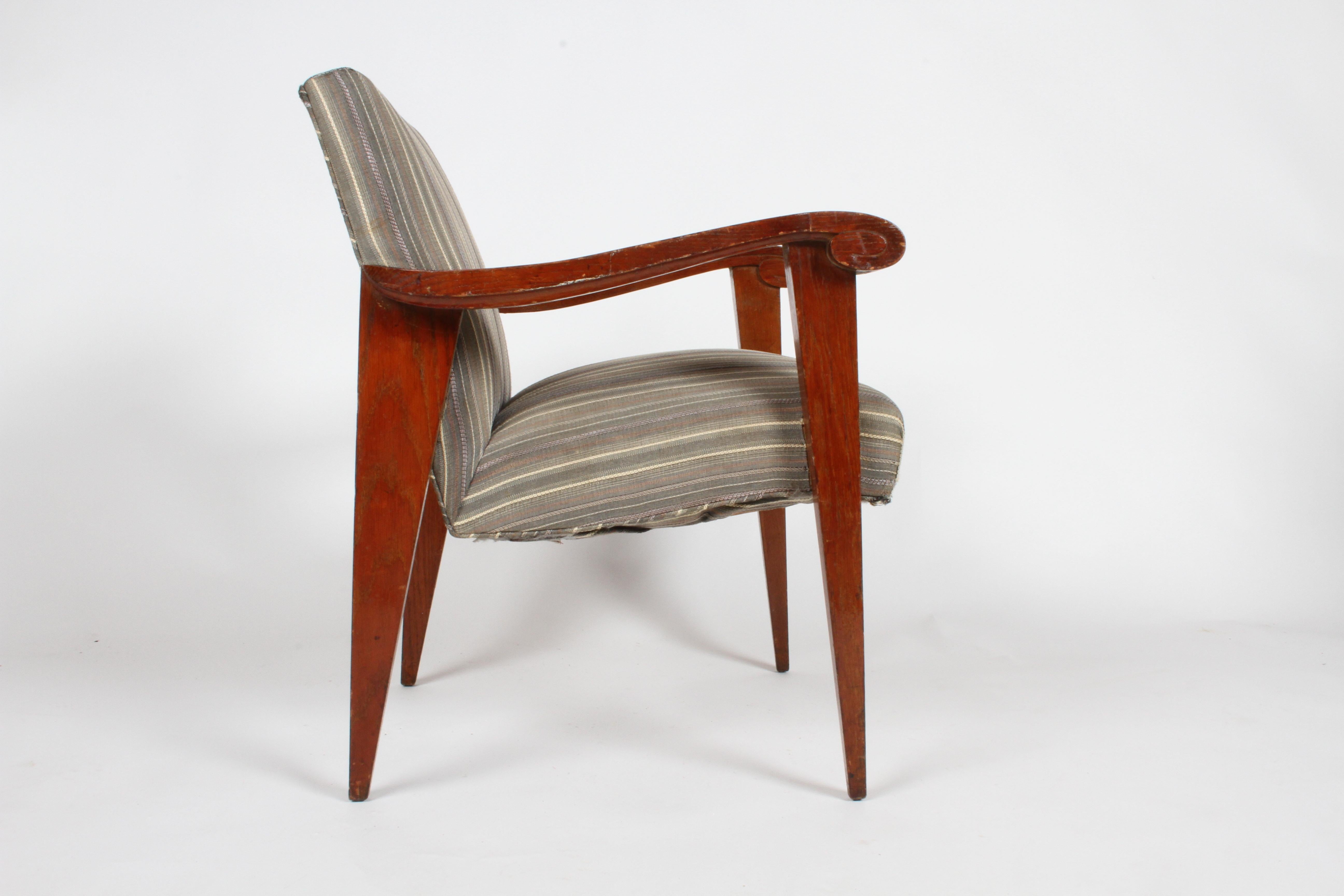 French deco, French Moderne or midcentury single armchair, circa 1940s with sculptural scroll arm and dramatic triangle form legs. Older upholstery should be updated, would look great with California sheep skin. Oak frame has wear, loss, will be