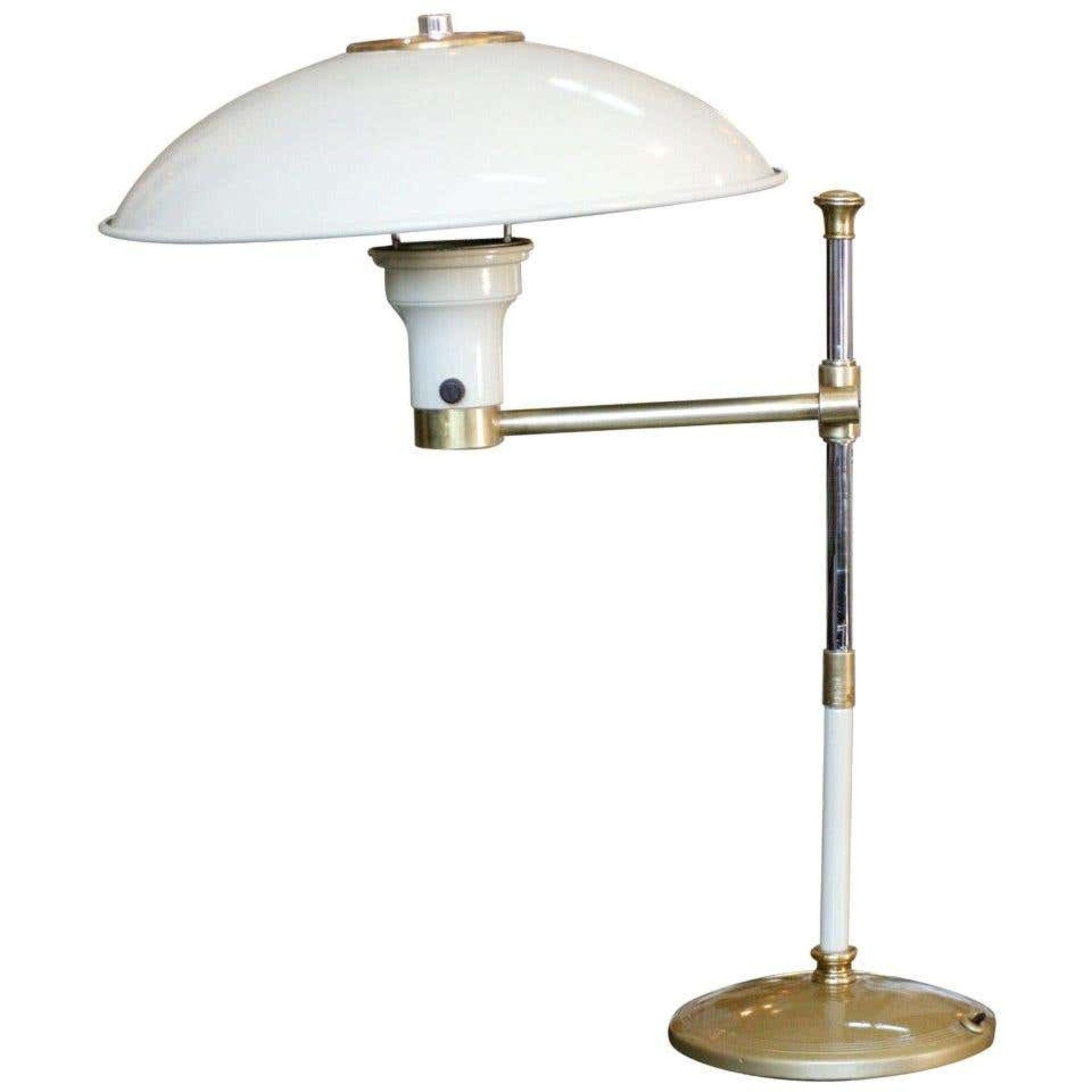 High style midcentury desk lamp with an enameled frostine white steel body and brass accents. The lamp features an adjustable arm and unique steel shade.
