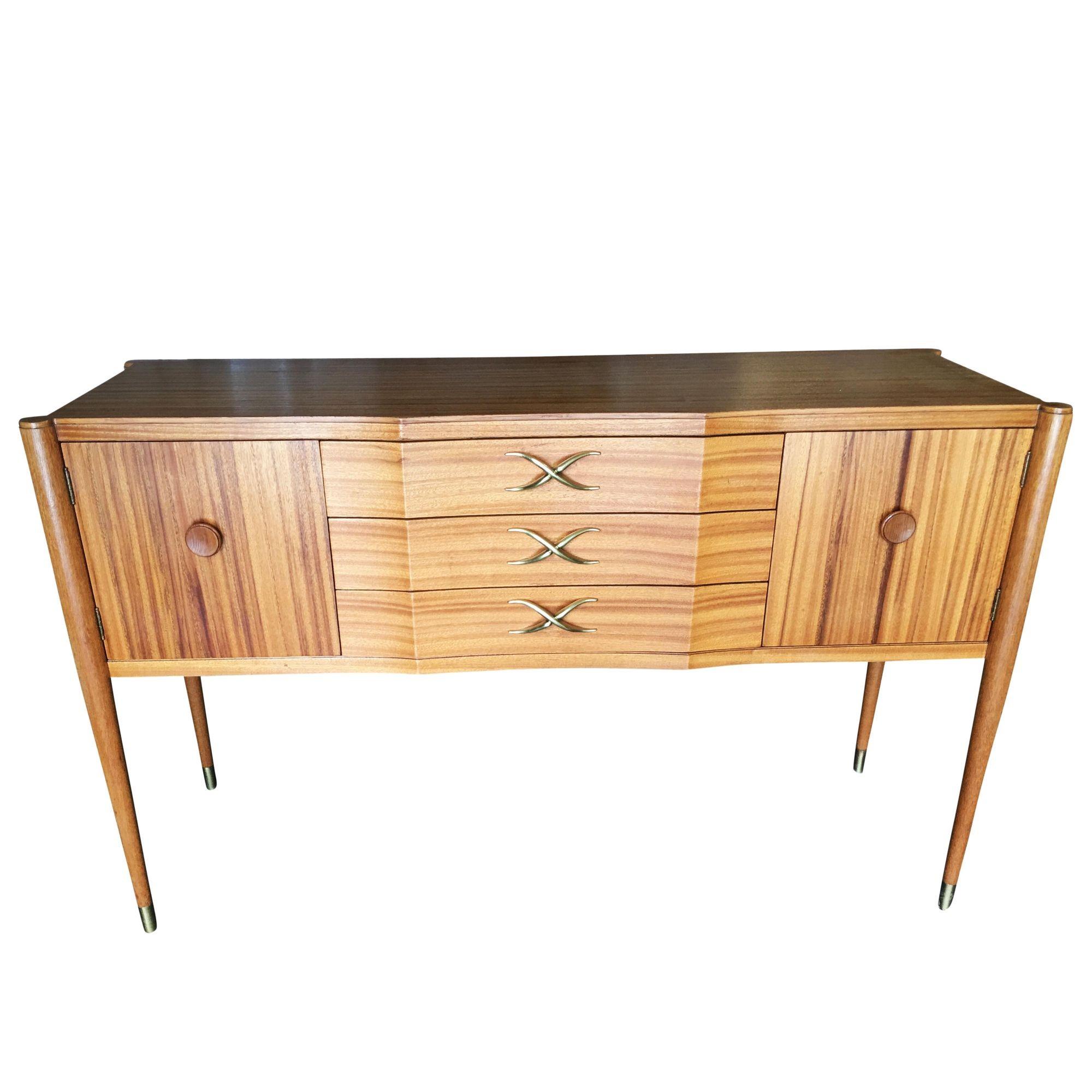 Midcentury mahogany sideboard by Paul Frankl featuring a slender cabinet on petite taper legs with 3 drawers and 2 front opening cabinets. This sideboard features the signature Frankl 