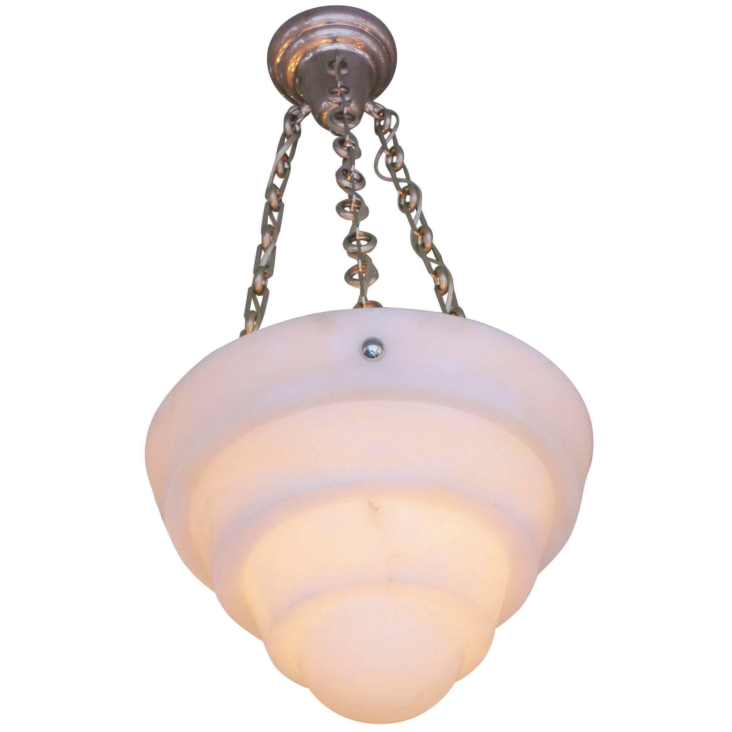 Large hand-carved stepped modern alabaster chandelier with silver plate bronze chains attached to a silver-plated bronze ceiling fixture. 

This large deep hand carved 14