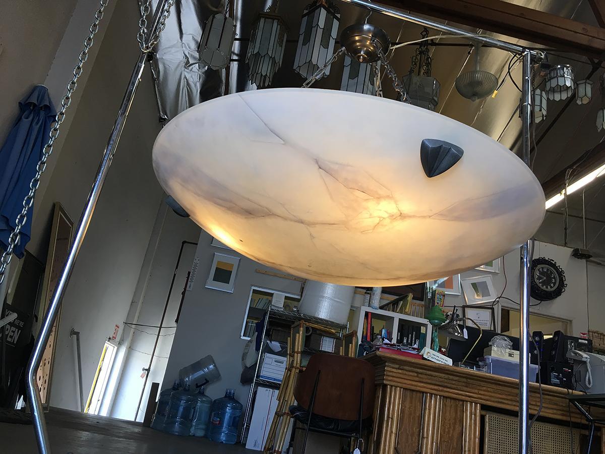 High style modern faux alabaster saucer chandelier featuring 3-light resting a large carved saucer with custom made drop chains.

addx1
   