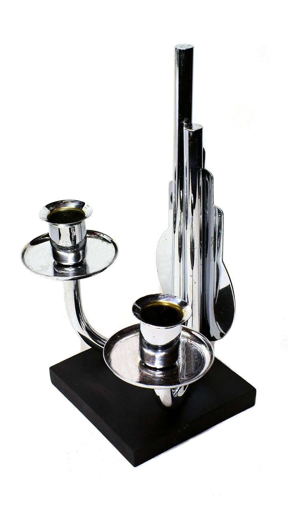 Modernist Art Deco candelabra in lacquered ebonised wood and chromed metal. Dating to the 1930s and originating from Belgium.
The condition of the chromium is very good but does show some signs of age as does the black wood.
 