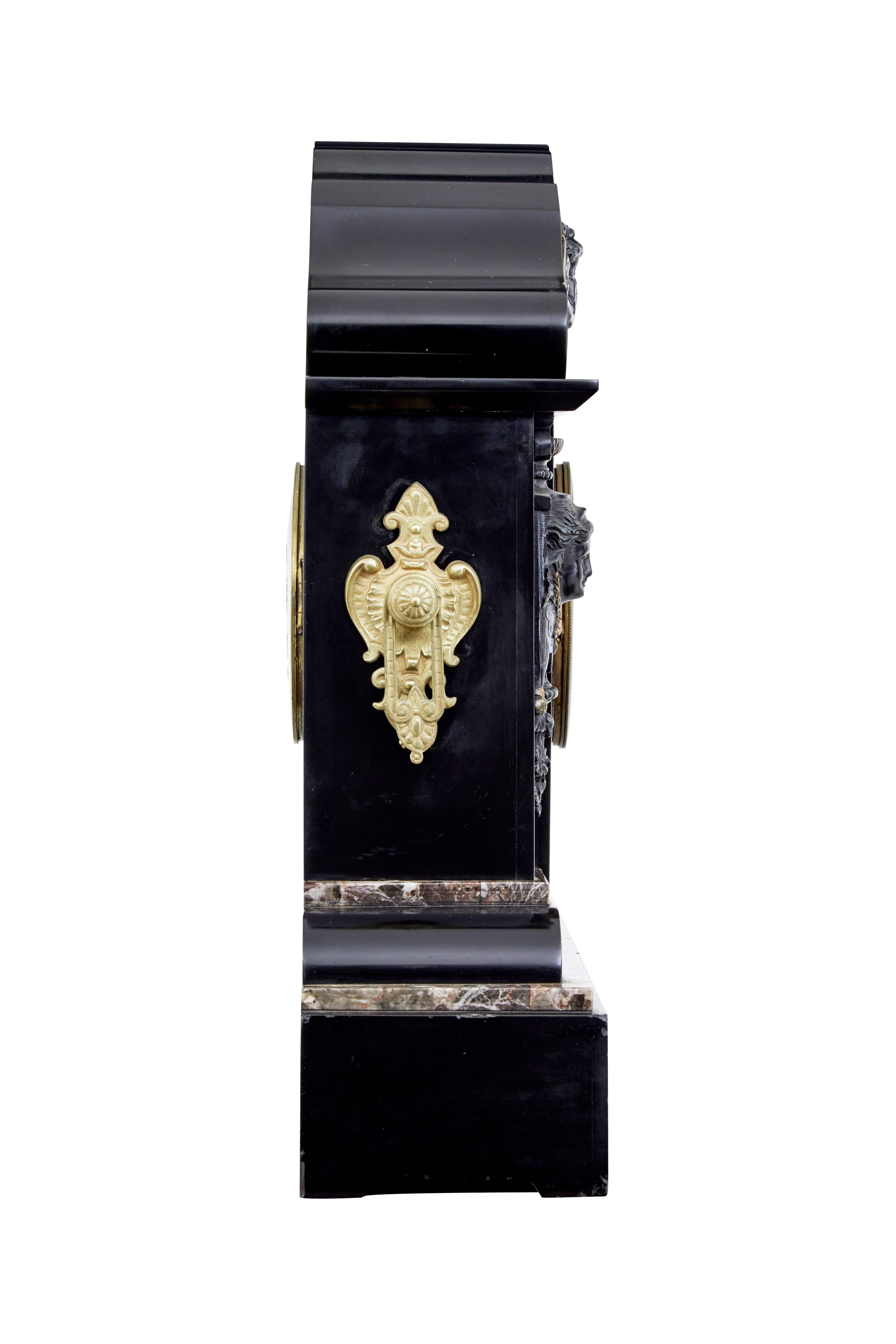 High victorian inlaid black marble mantel clock circa 1870.

Fine quality mantel clock of large proportions from the period in Victorias reign when it was in vogue to commemorate the death of Prince Albert.  Shaped architectural top with carved