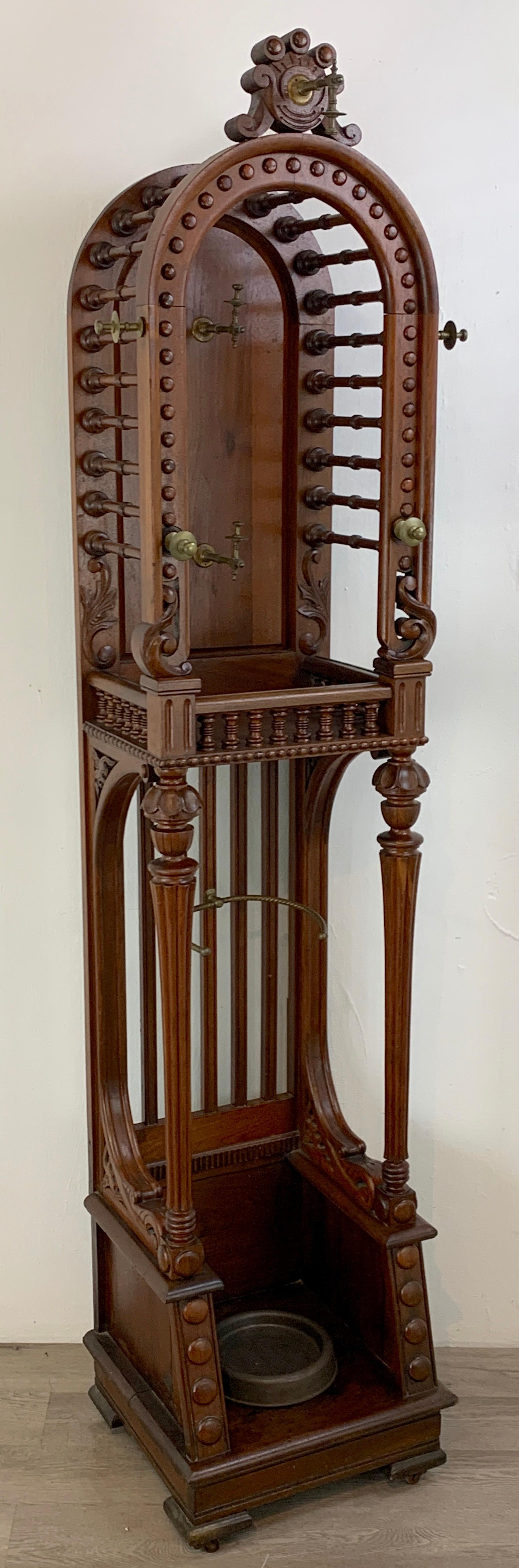 High Victorian stick and ball variation hall rack, attributed to Hunzinger. Rare form, tall and narrow with domed top fitted with brass hooks, the upper section measures 15
