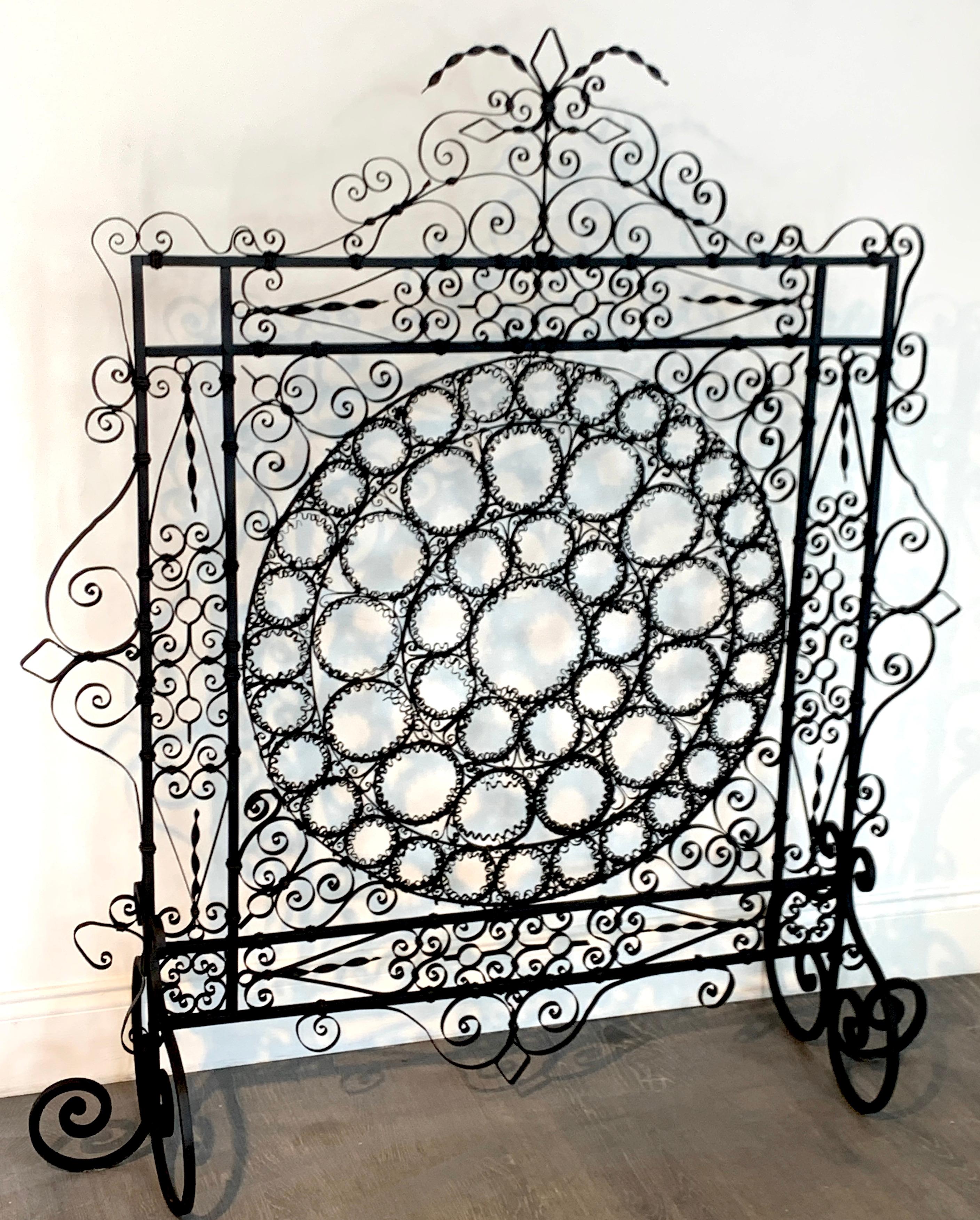 High Victorian wrought iron wire work medallion fires screen, a substantial screen with intricate wrought iron wire work, with a 26-inch diameter medallion.
 