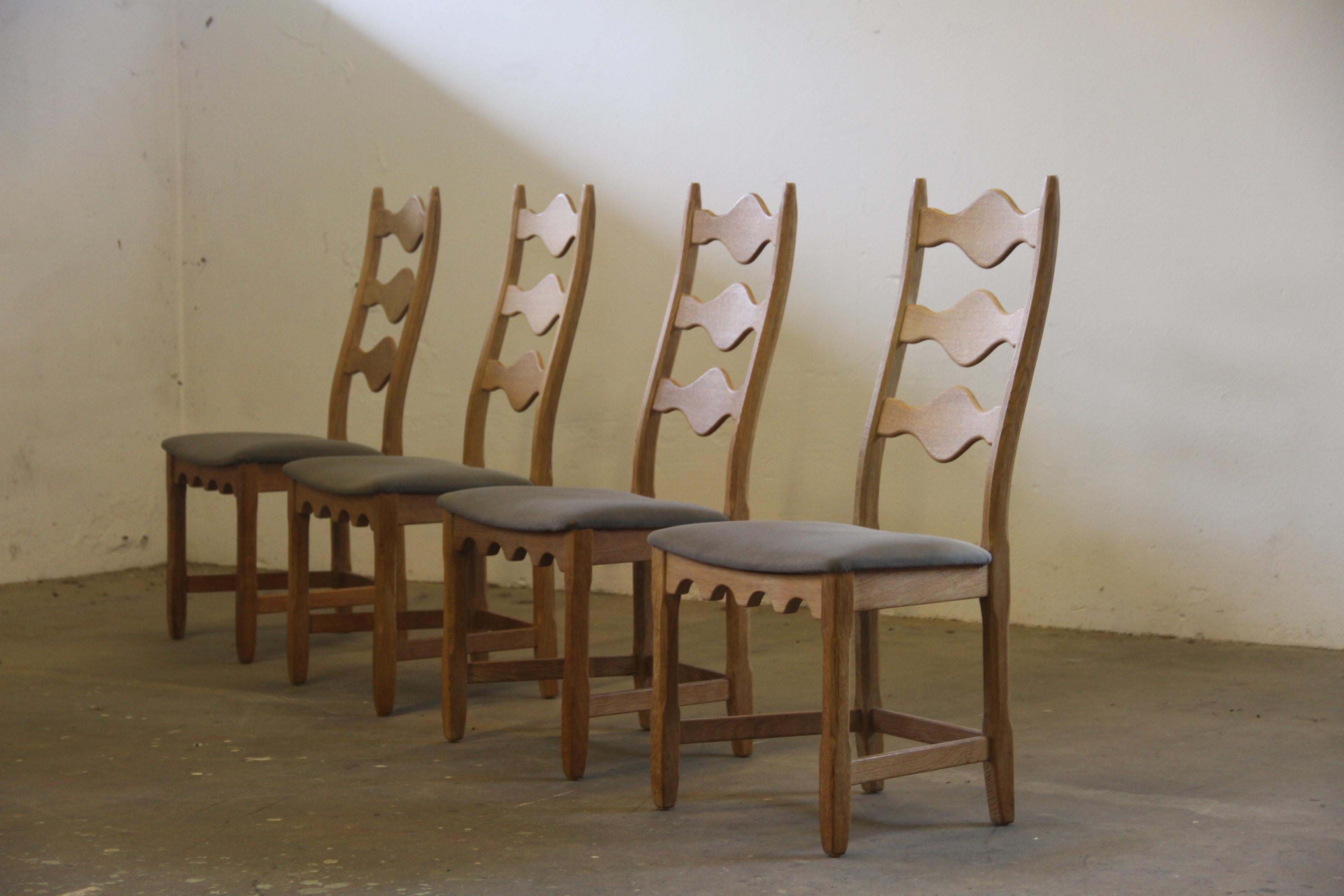 This set of four carved light oak ladder-back chairs, familiar to the 