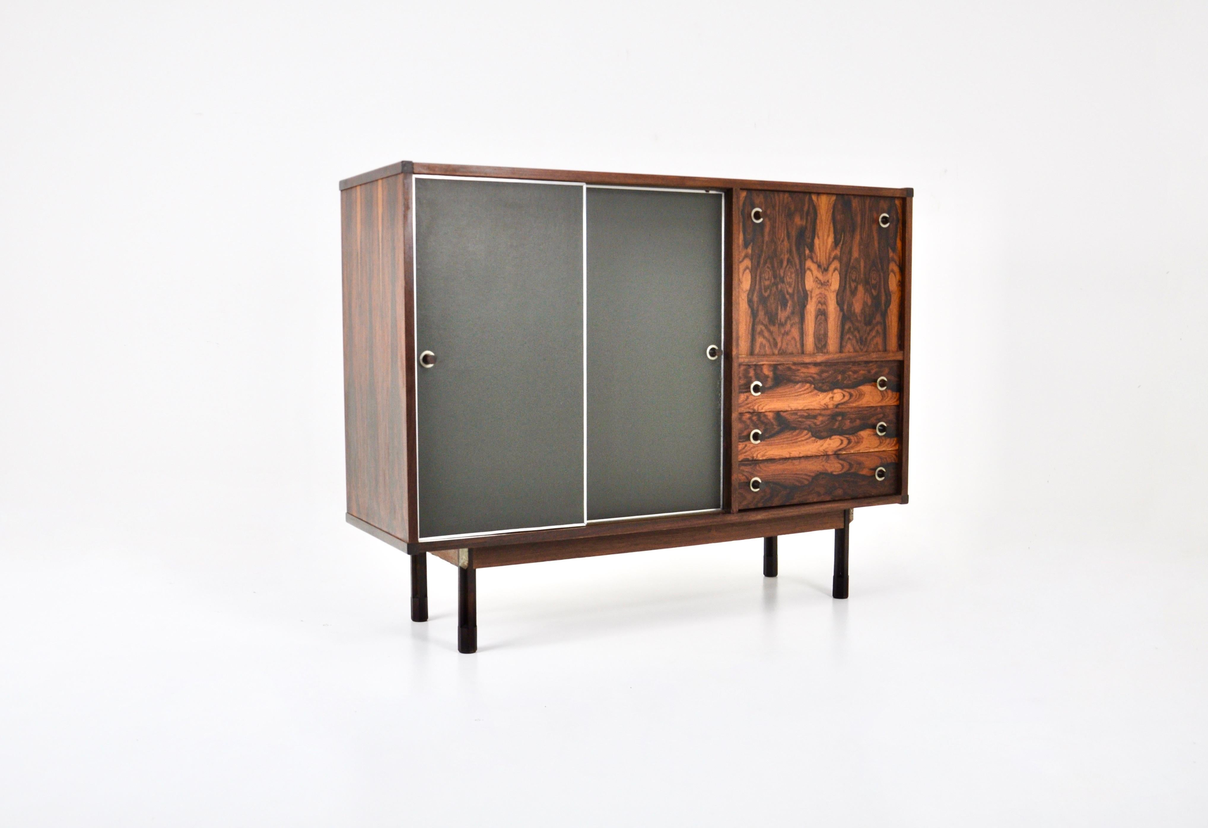 Highboard with several storage spaces consisting of 2 black sliding doors, a folding door and 3 drawers. Designed by George Coslin in the 60s. Wear due to time and age
 