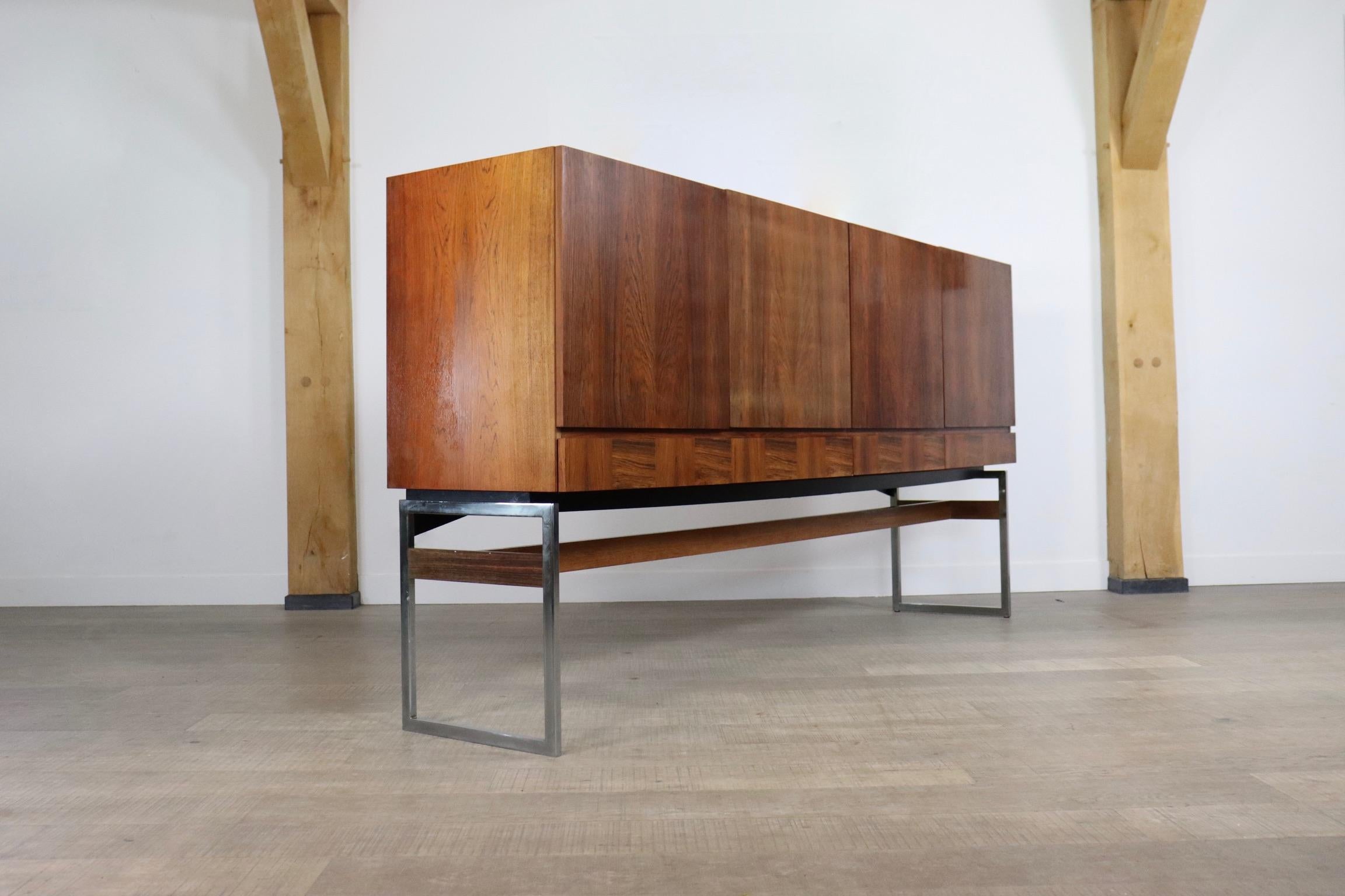 Incredible and unique highboard designed by Rudolf Glatzel for Fristho Franeker, Holland. 
The large storage space is besides its sophisticated design something that might catch you eye. The rosewood and chrome combination makes this highboard