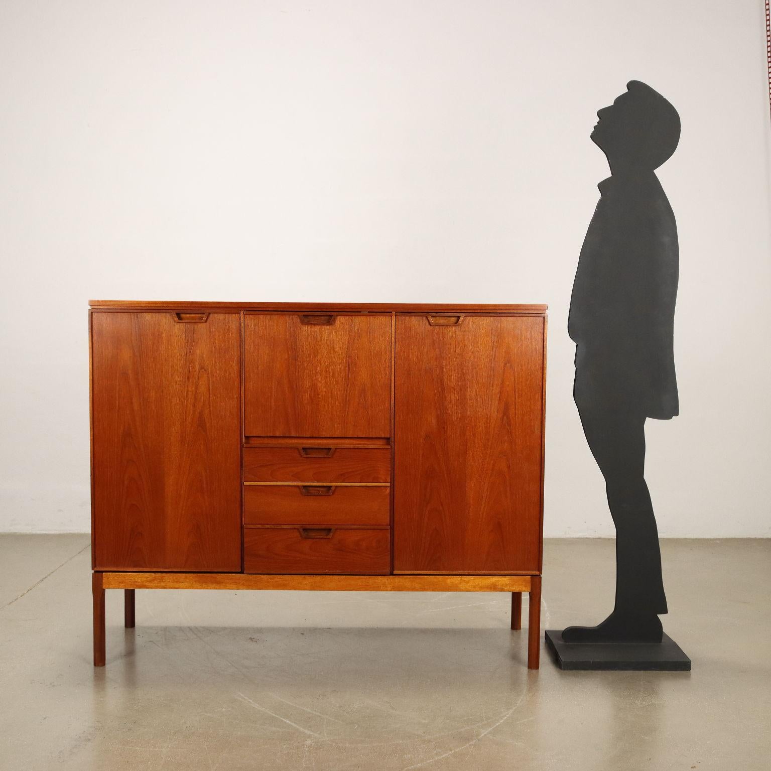 Highboard with hinged doors, exposed drawers and flap for bar compartment. Solid wood and Teak veneer. Completely Restored. 