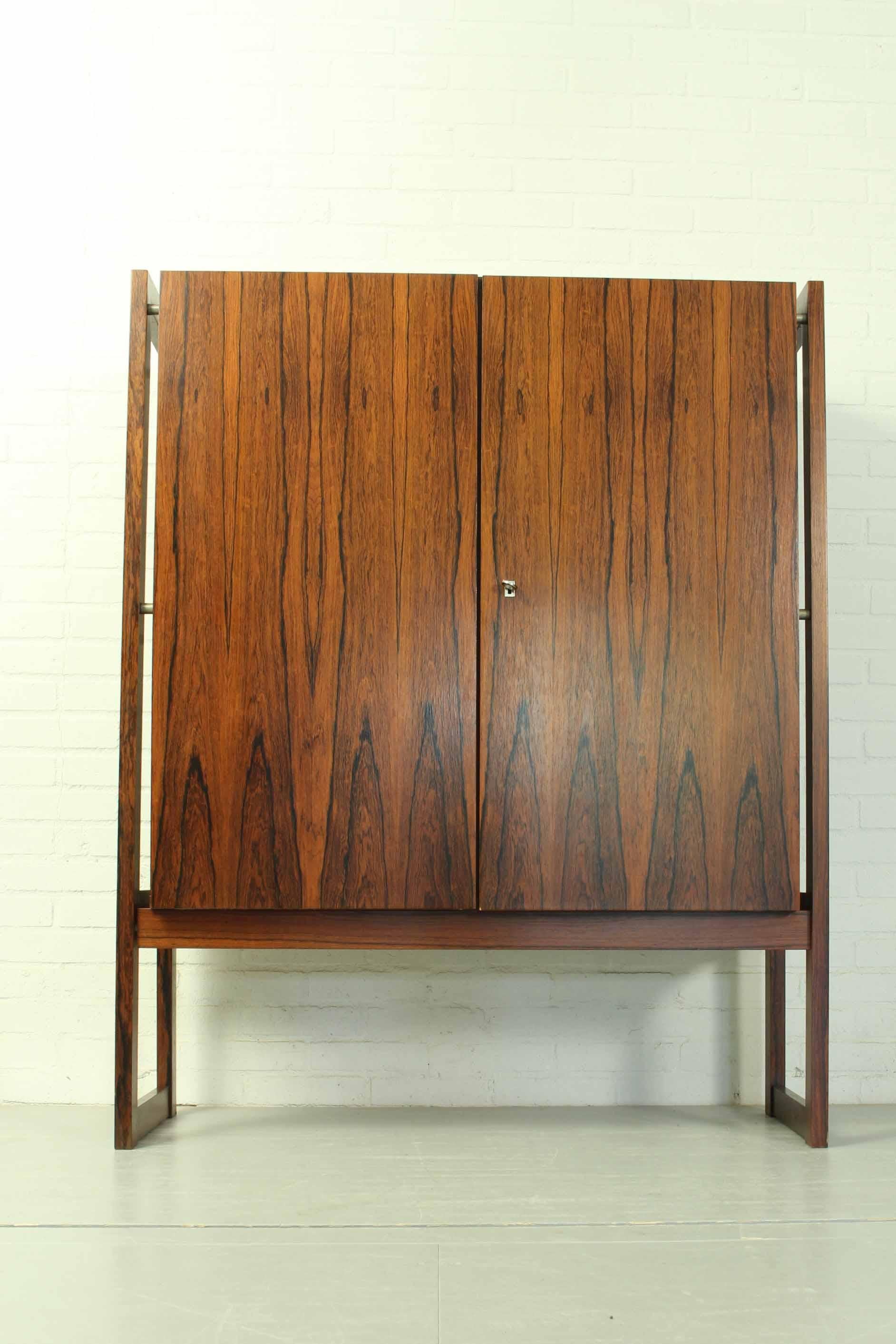 Rosewood Highboard “Malmo” within wood frame, executed in Rio Palissander. A very nice interior statement piece. Origination: Germany, late 1960s. 

Dimensions: 133cm h, 107cm w, 45cm d.
 