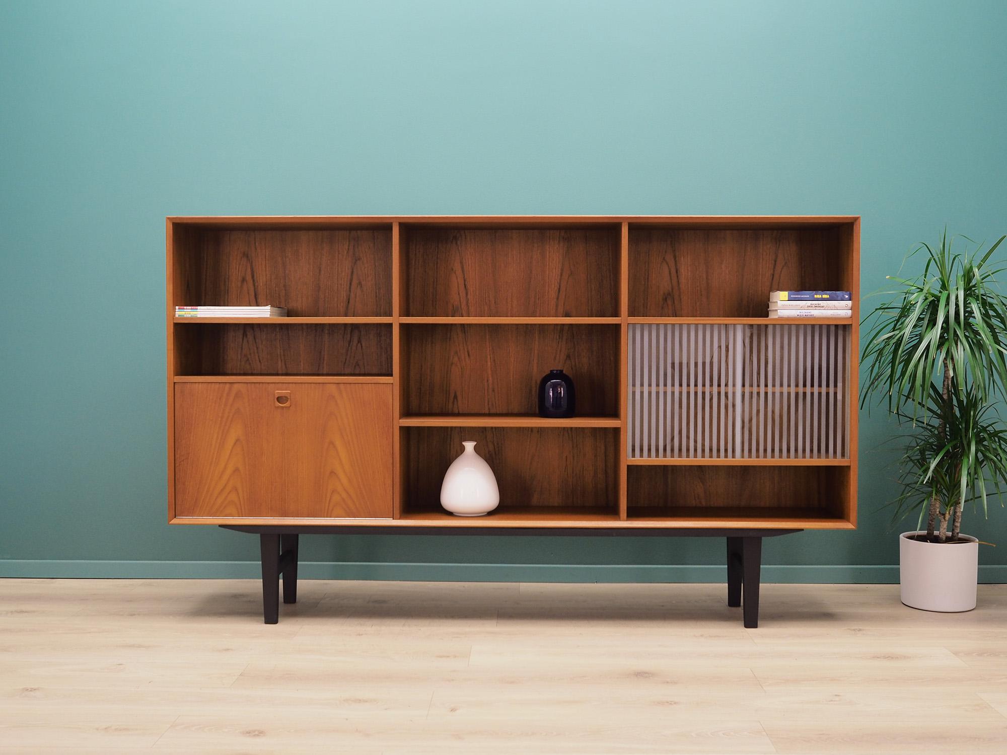 Highboard was made in the 1970s, Danish production.

Structure is covered with teak veneer. Legs made of solid wood stained black. Surface after refreshing. Inside the space has been filled with practical shelves, the lower middle shelf is