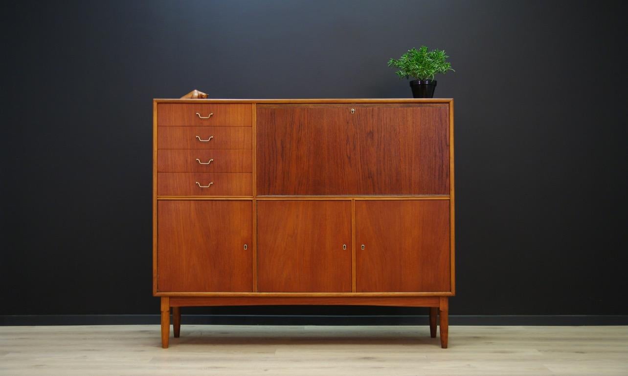 Magnificent highboard from the 1960s-1970s, a beautiful minimalist form - Scandinavian design. Surface is veneered with teak wood. A bar, four drawers and shelves behind the doors. The key in the set. Preserved in good condition (visible small dings