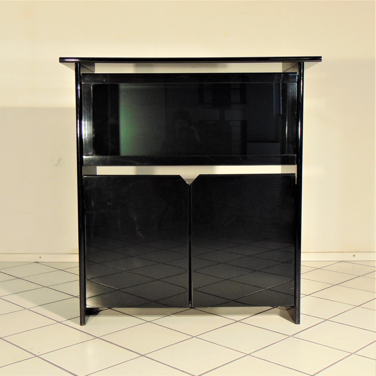 A highboard of the fabulous 1980s with a smoked glass vitrine with a tilt door. 
The lower part has two doors and one inner shelf, the upper part with the vitrine has two side compartments with two smaller shelves each and a larger central