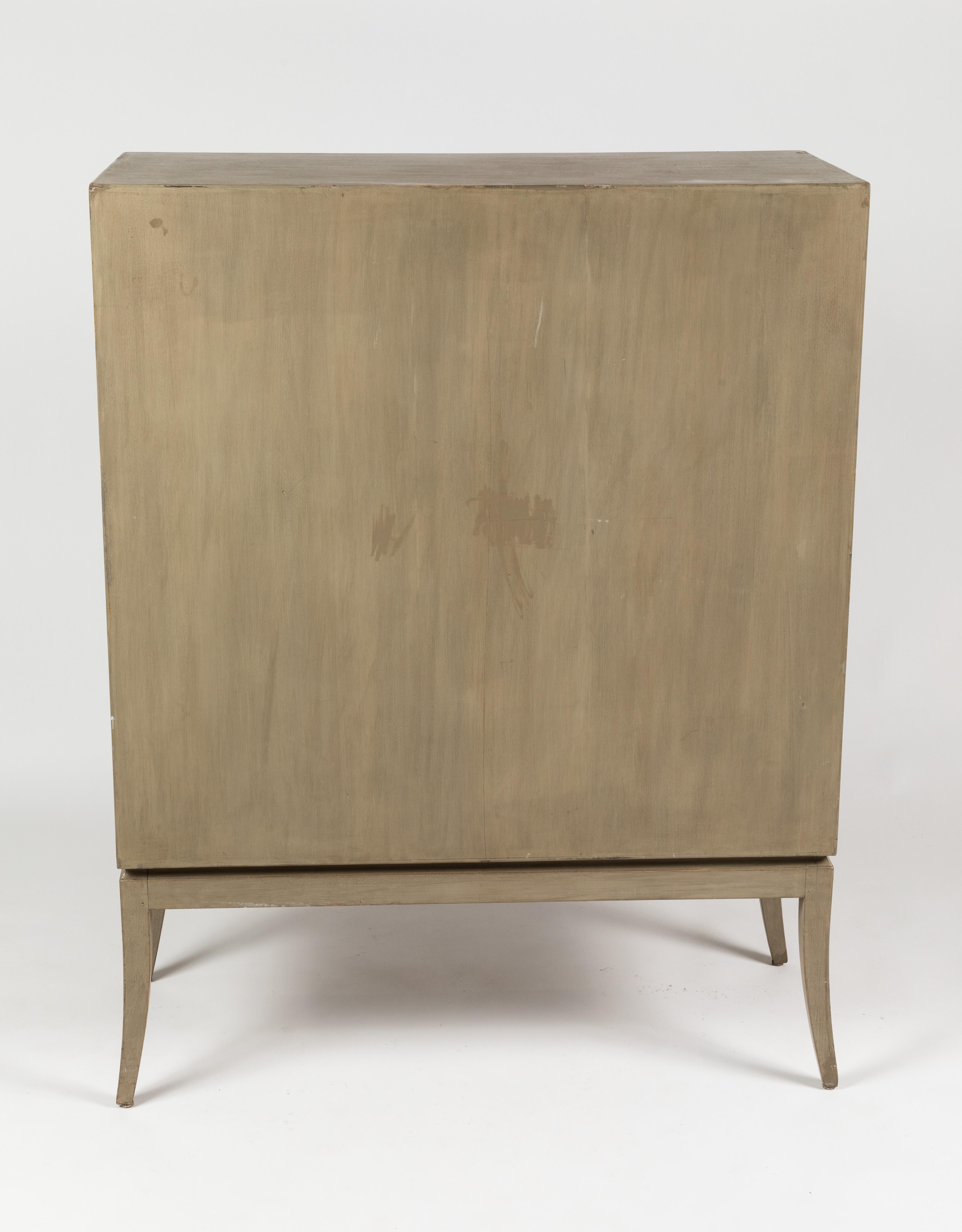 Rare Tommi Parzinger highboy featuring the original greyed wood finish along with the handmade polished brass hardware. This is part of the original collection released by Charak Modern as part of Mr. Parzinger's first collection. Charak was a