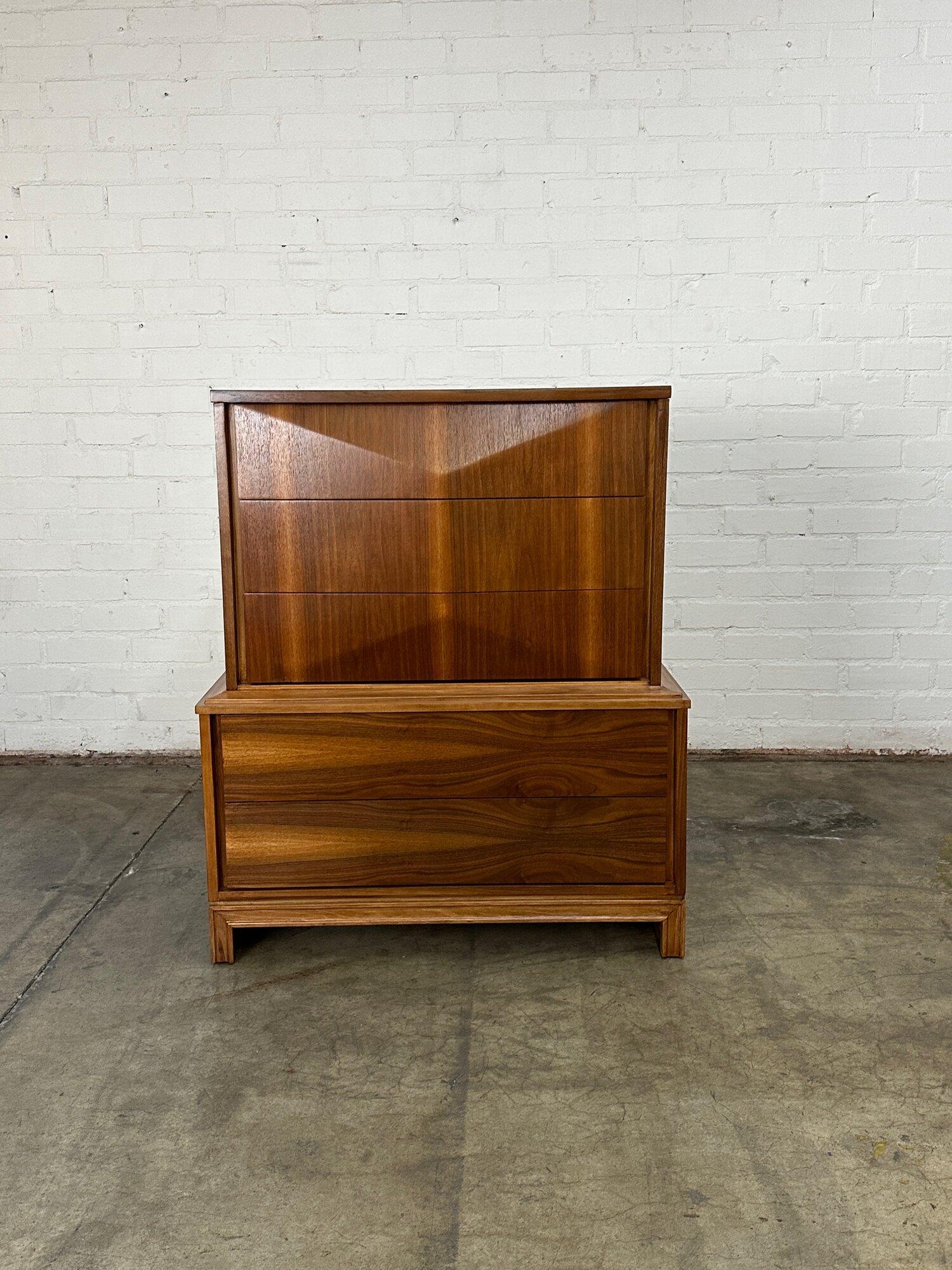 W40 D20 H47.5

Fully restored walnut highboy dresser. Item features exceptional walnut grain and has been clear coated to show natural wood tones. Item features hidden pulls on the sides and a great diamond surface on the top drawers. Highboy is