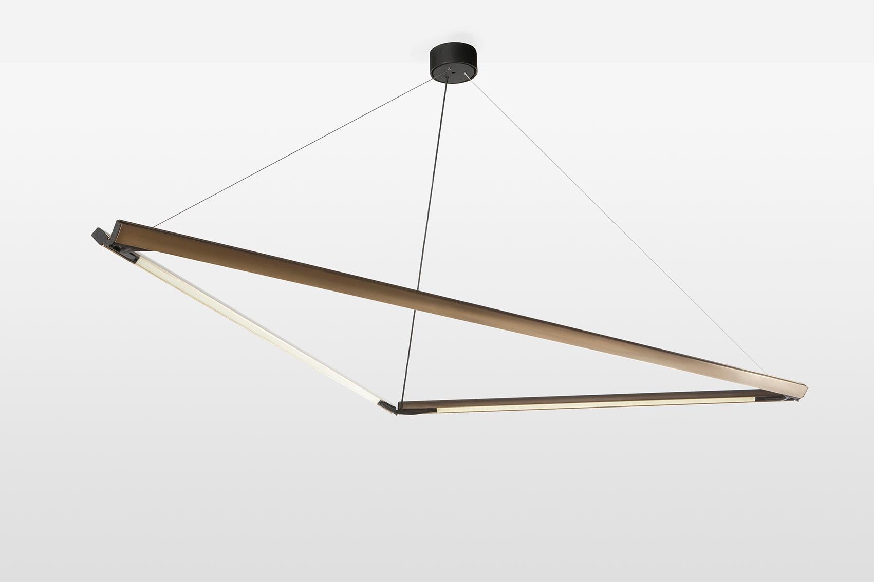 Highline 3D is an architectural lighting system with infinite possibilities. A custom brass extruded profile with inlaid LEDs creates the foundation for a variety of geometric volumes. The 3D_01 version is an obtuse triangle that looks visually