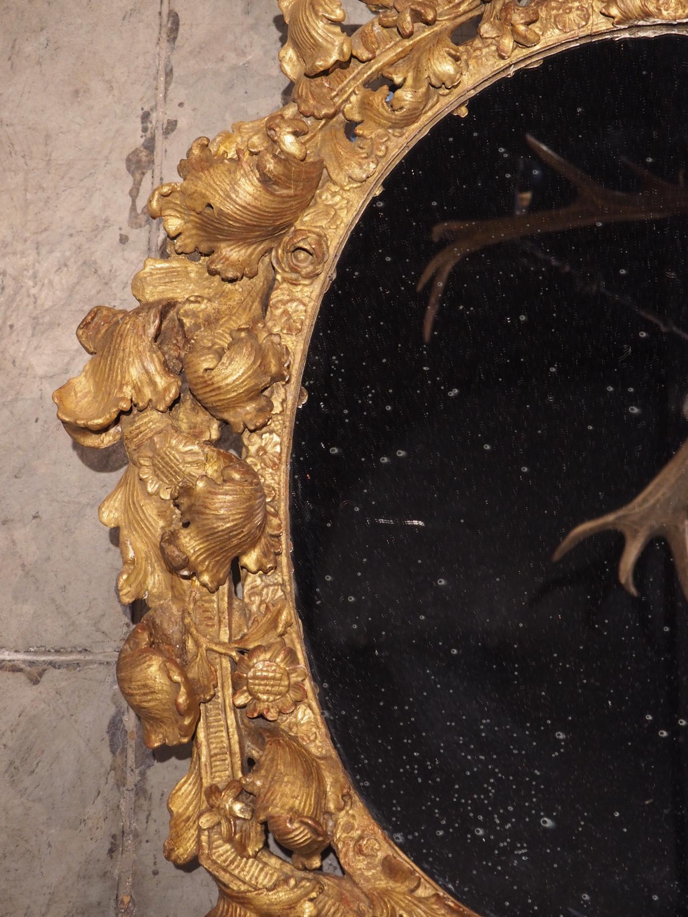 Highly Carved 17th Century Giltwood Mirror from France 11