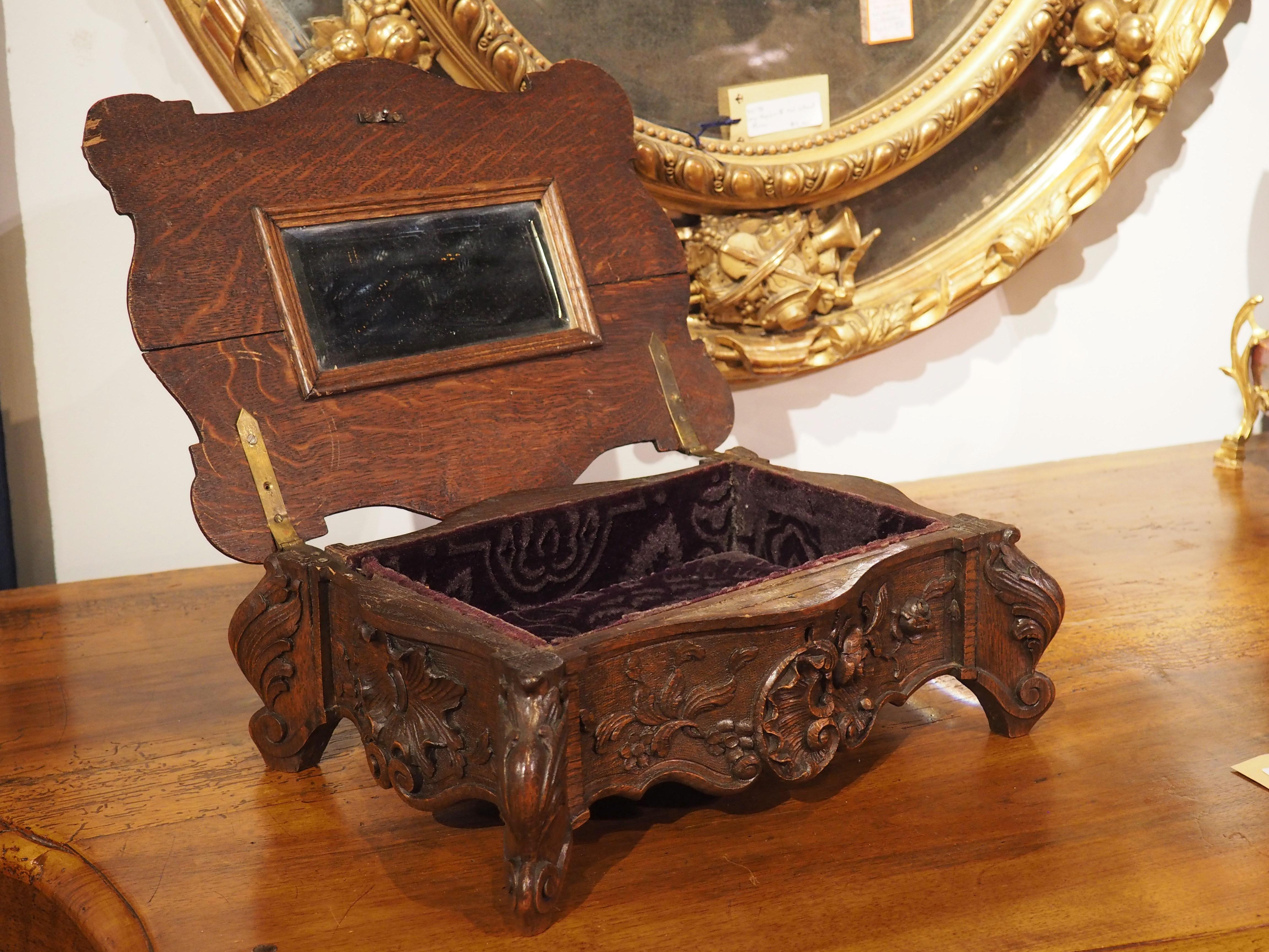This beautifully carved oak box is perfect for storing small valuables and jewelry.  Crafted in France in the latter half of the 1800s,  this decorative box stands on acanthus carved legs terminating in scrolled feet. The high quality carving adorns