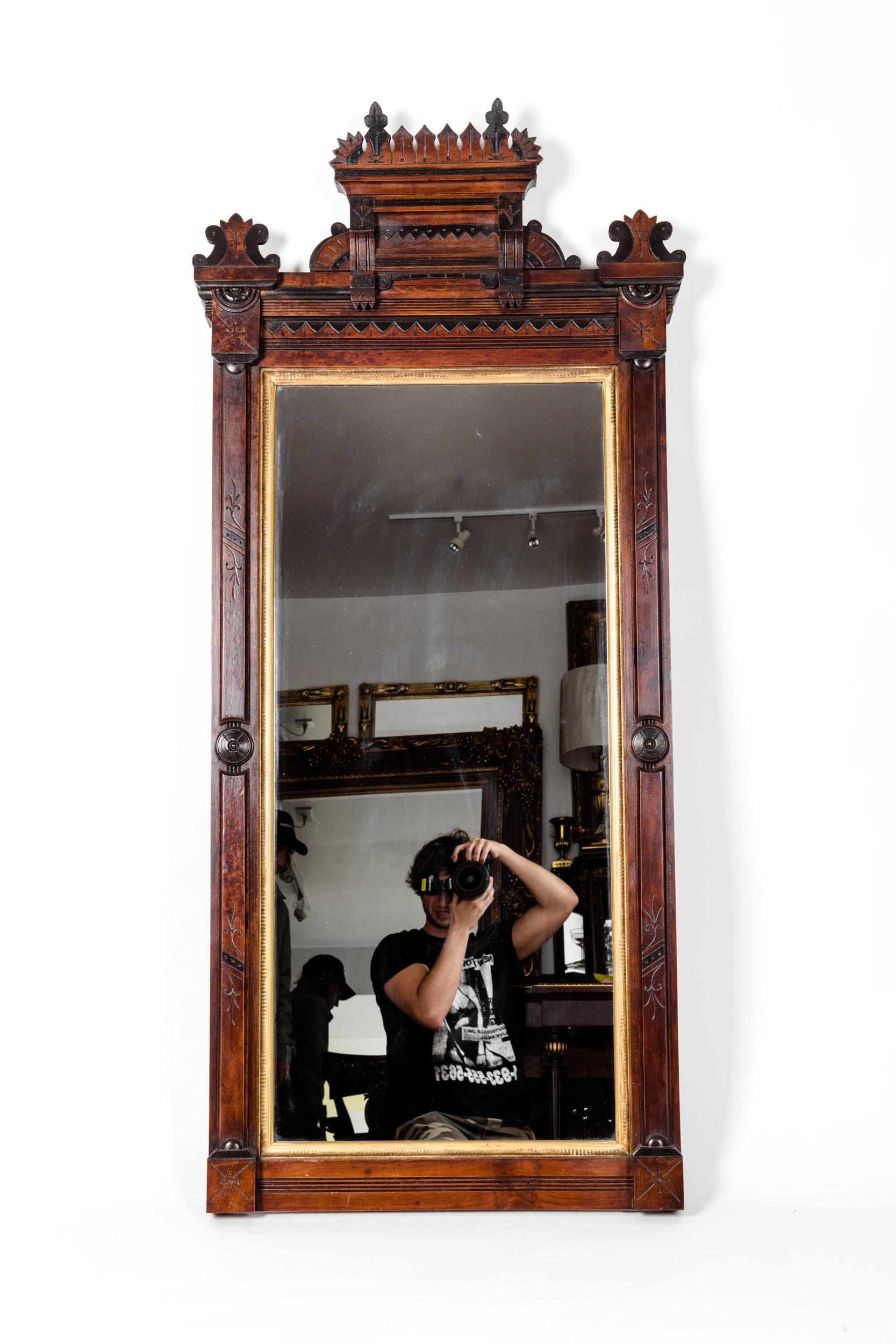 Highly carved mahogany wood framed with gold leaf details Victorian style rectangle hanging wall mirror. Finely carved wood arch design top. The mirror is in excellent antique condition. Minor wear consistent with age or use. The mirror measure