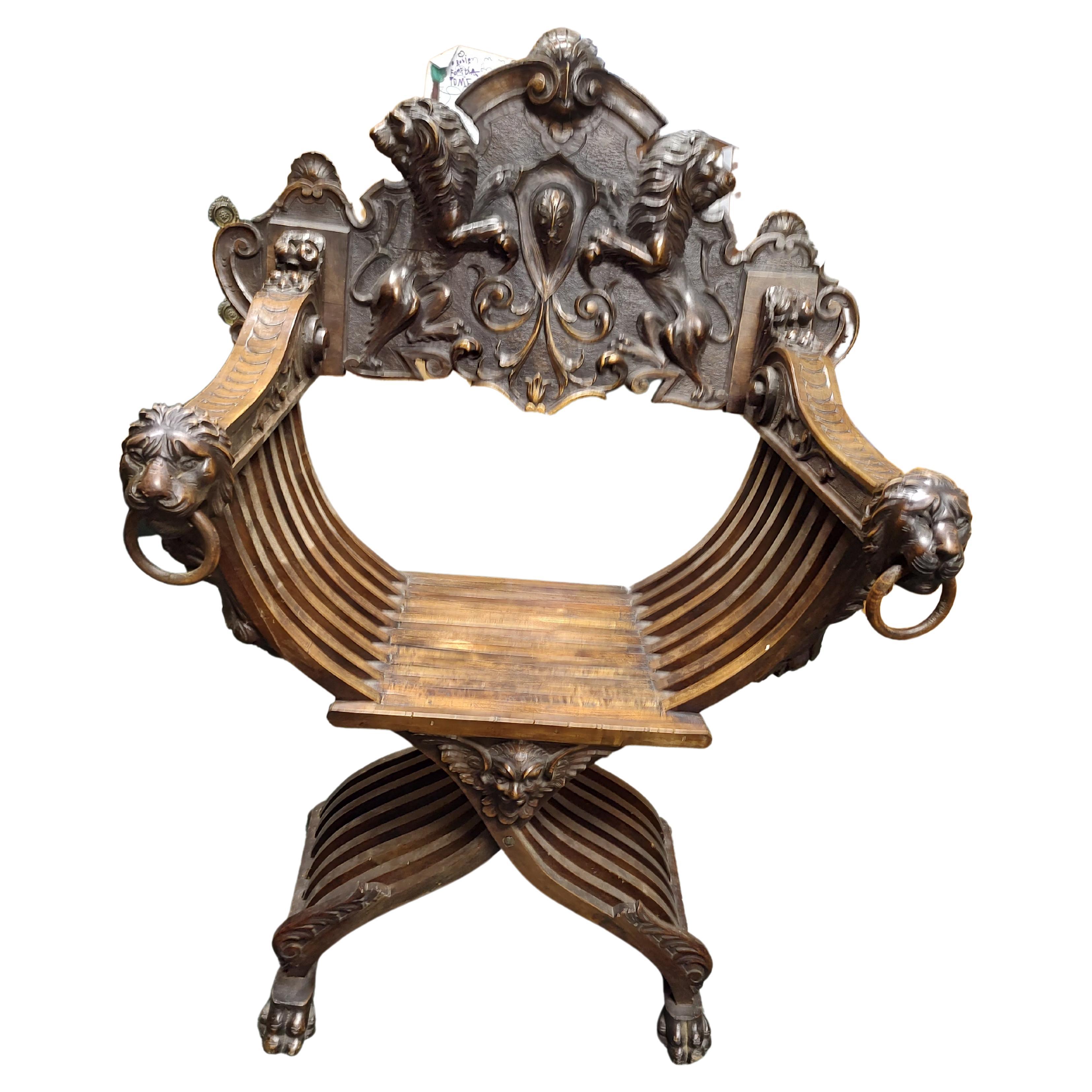 Fabulous highly carved chair with full lions and dog heads. The chairs design dates back to the Roman Empire with of course different designs in the chair. Backrest lifts off and mechanical chair collapses. Made entirely of Walnut, chair is in