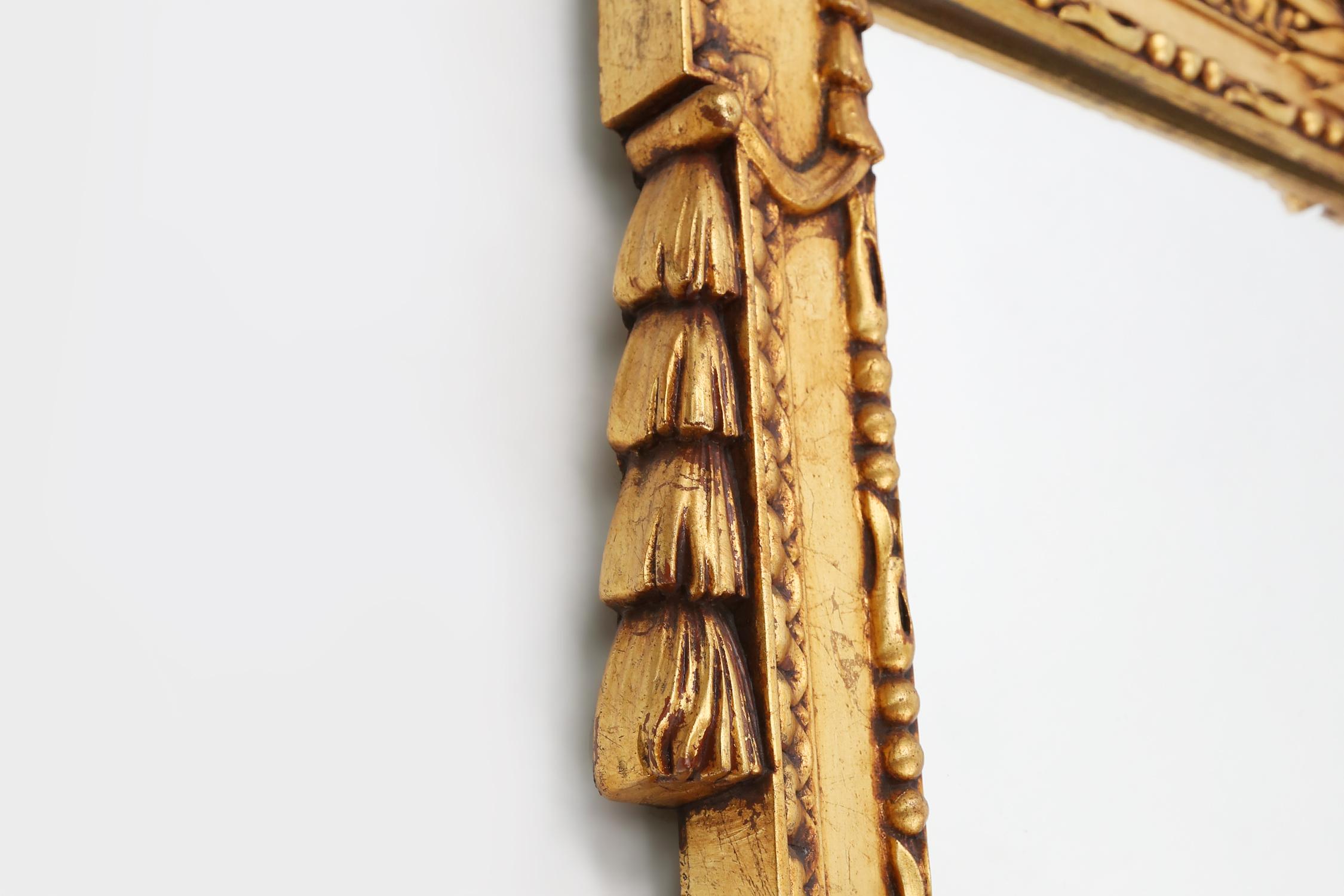 Belgian Highly decorated gilted carved wooden wall mirror, Belgium ca. 1950 For Sale