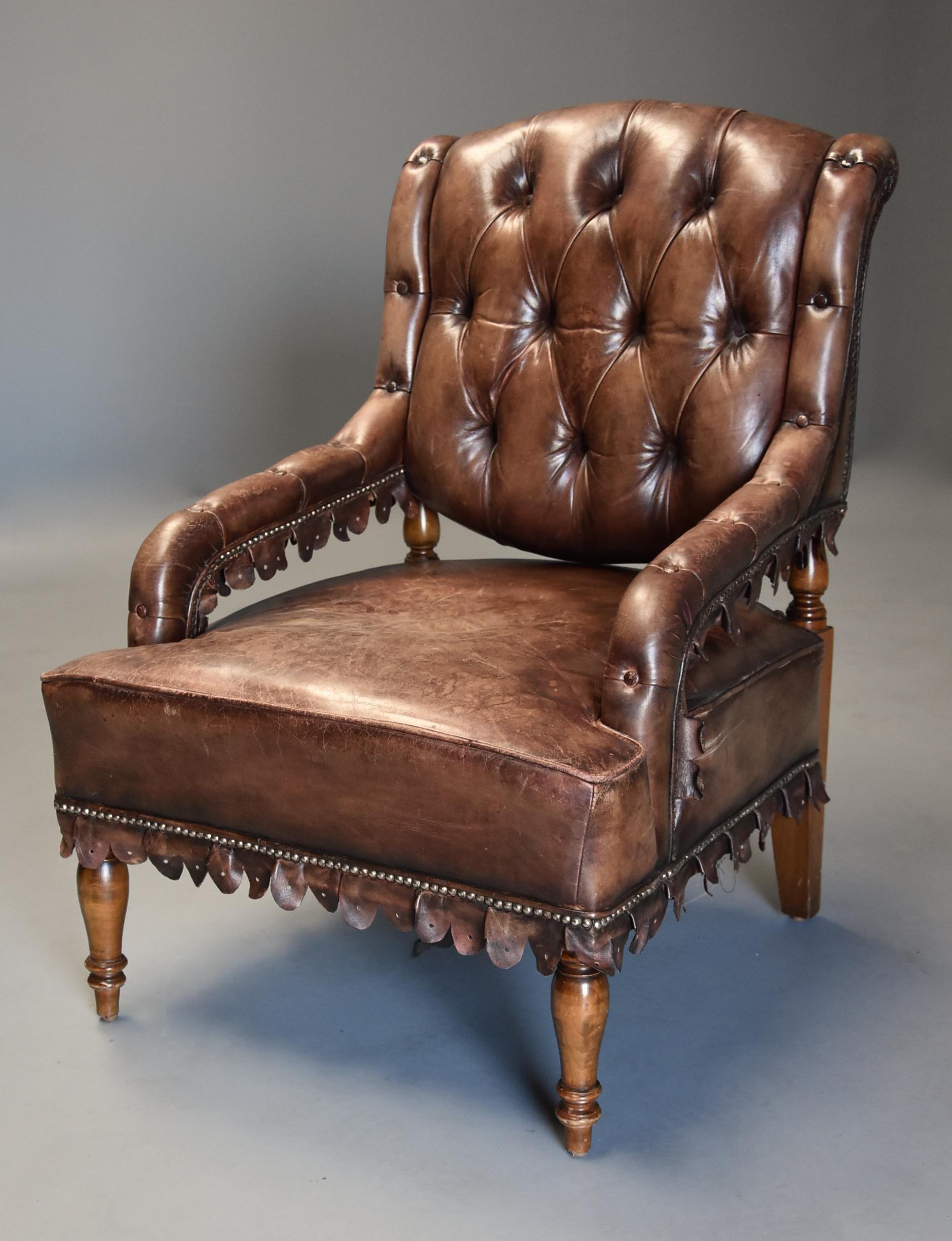 A highly decorative and unusual 1930s French brown leather open armchair, the leather of nicely worn appearance.

This chair consists of a shaped deep buttoned back with turned beech supports with deep buttoned leather arms with brass dome head
