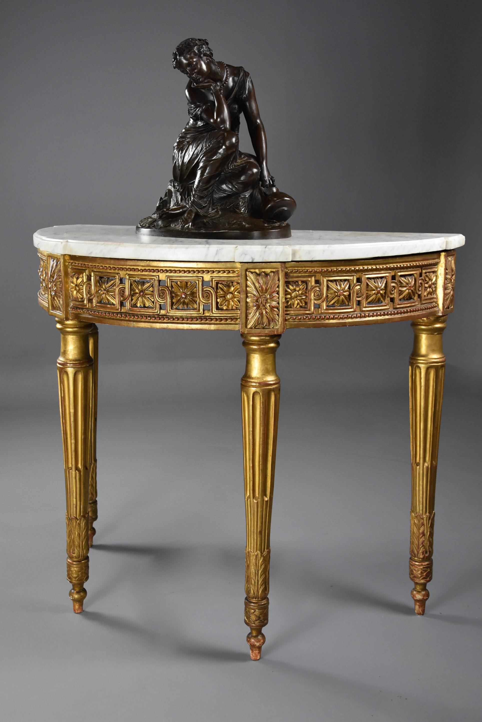 A highly decorative late 19th century French demilune gilt console table.

This table consists of a demilune shaped white marble top, the top with evidence of an old repair but in stable condition. 

The top is supported by a finely carved