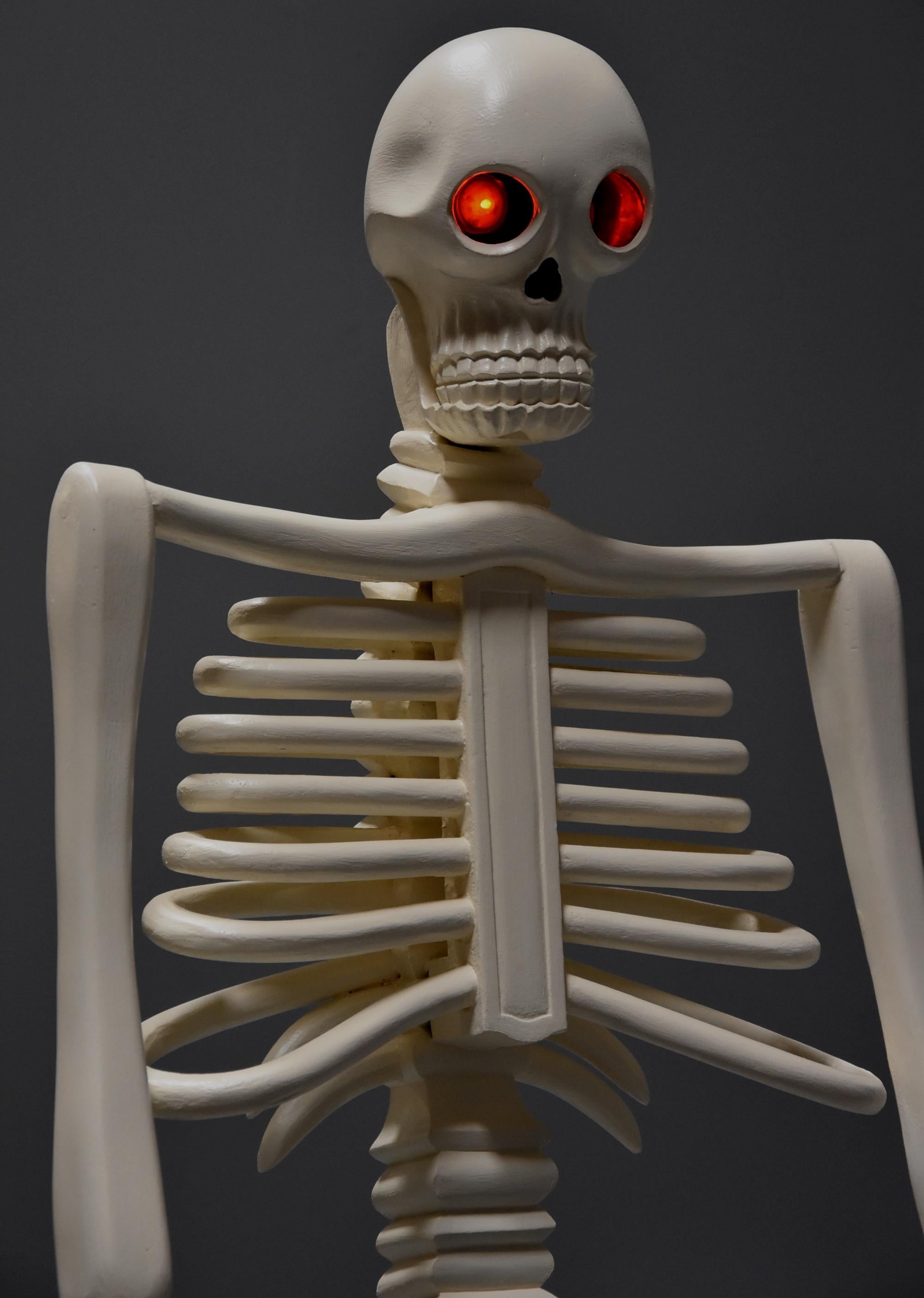 skeleton sitting in chair