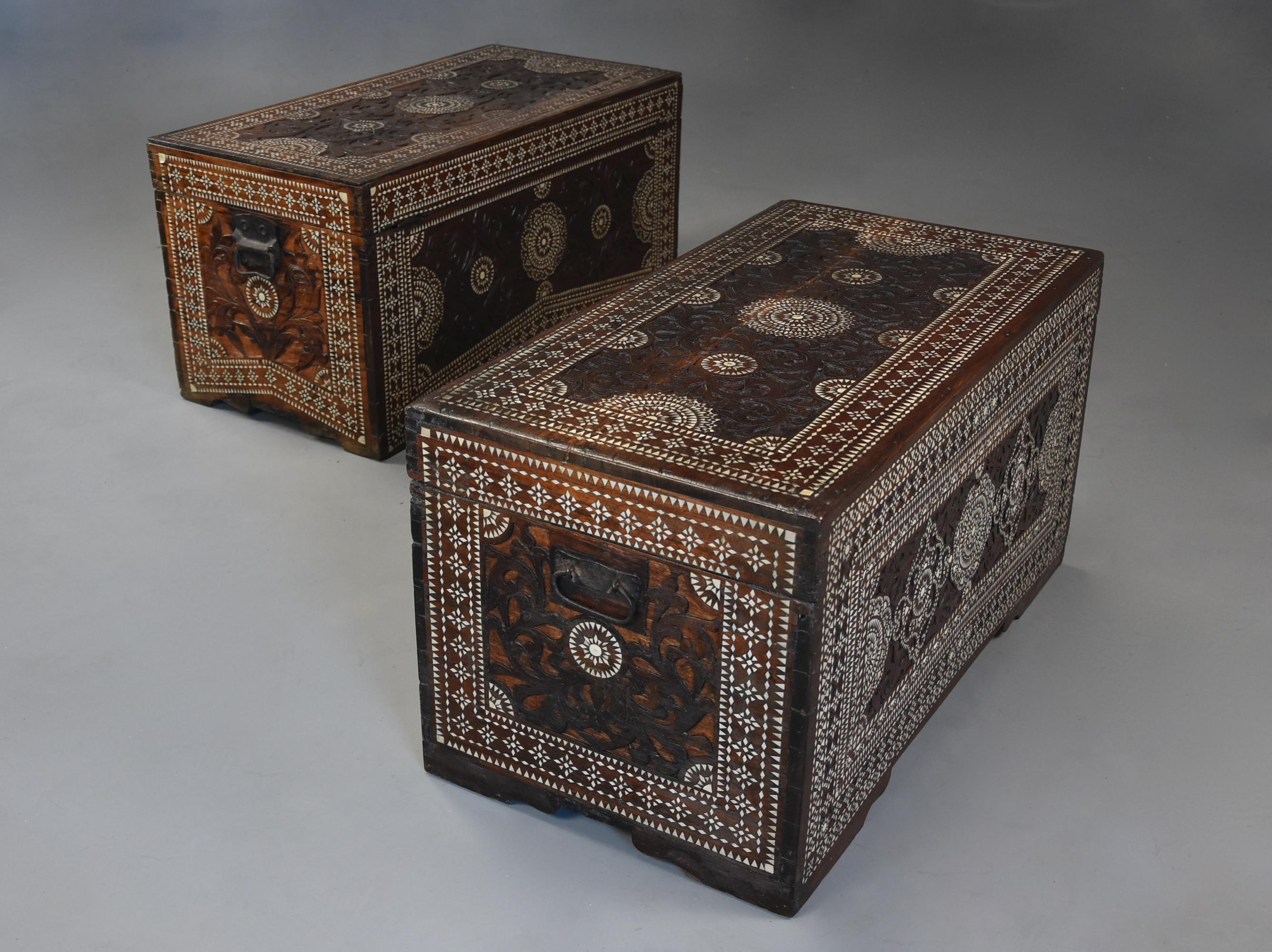 Highly decorative near pair of early 20th century hardwood and mother of pearl Syrian trunks or chests.

The trunks consist of foliate carved tops with inlaid mother of pearl circle decoration with a border of geometric designs.

The foliate