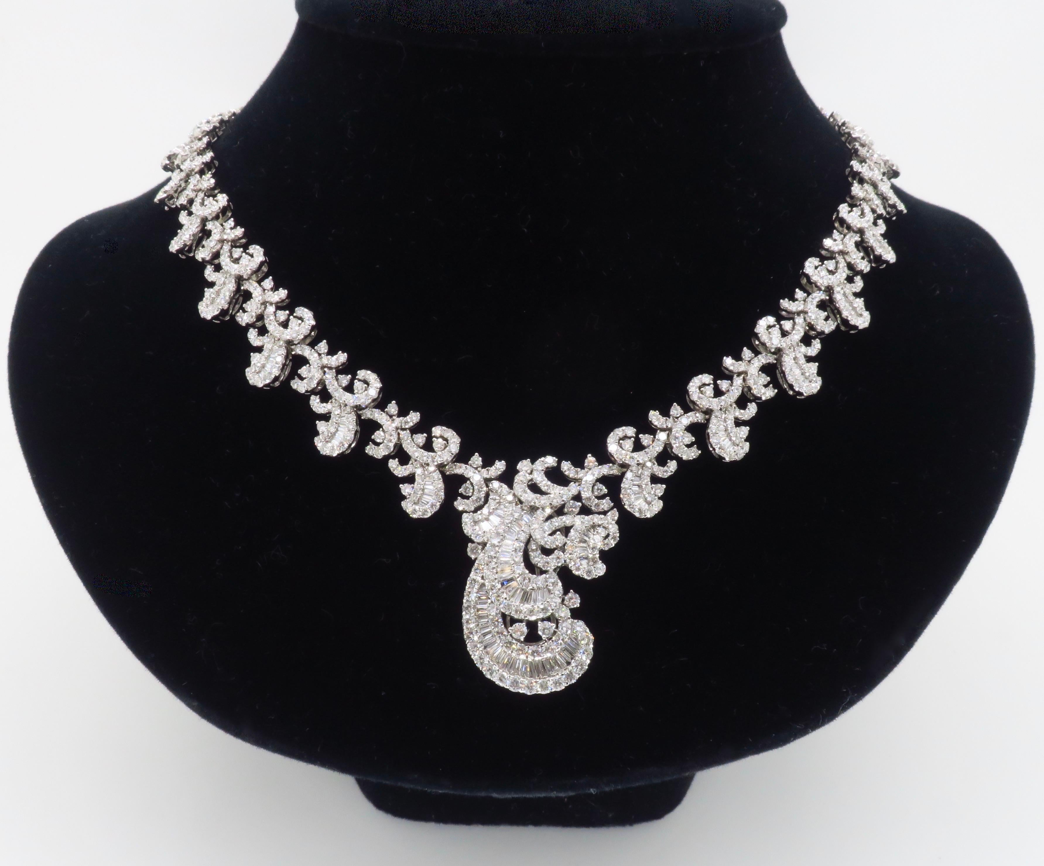 Intricate diamond necklace made in 18k white gold with 18.96ctw of diamonds. 

Total Diamond Carat Weight: 18.96CTW
Diamond Cut: Round Brilliant Cut & Baguette Cut 
Color: F-H
Clarity: VS-SI
Metal: 14K White Gold
Stamped: 