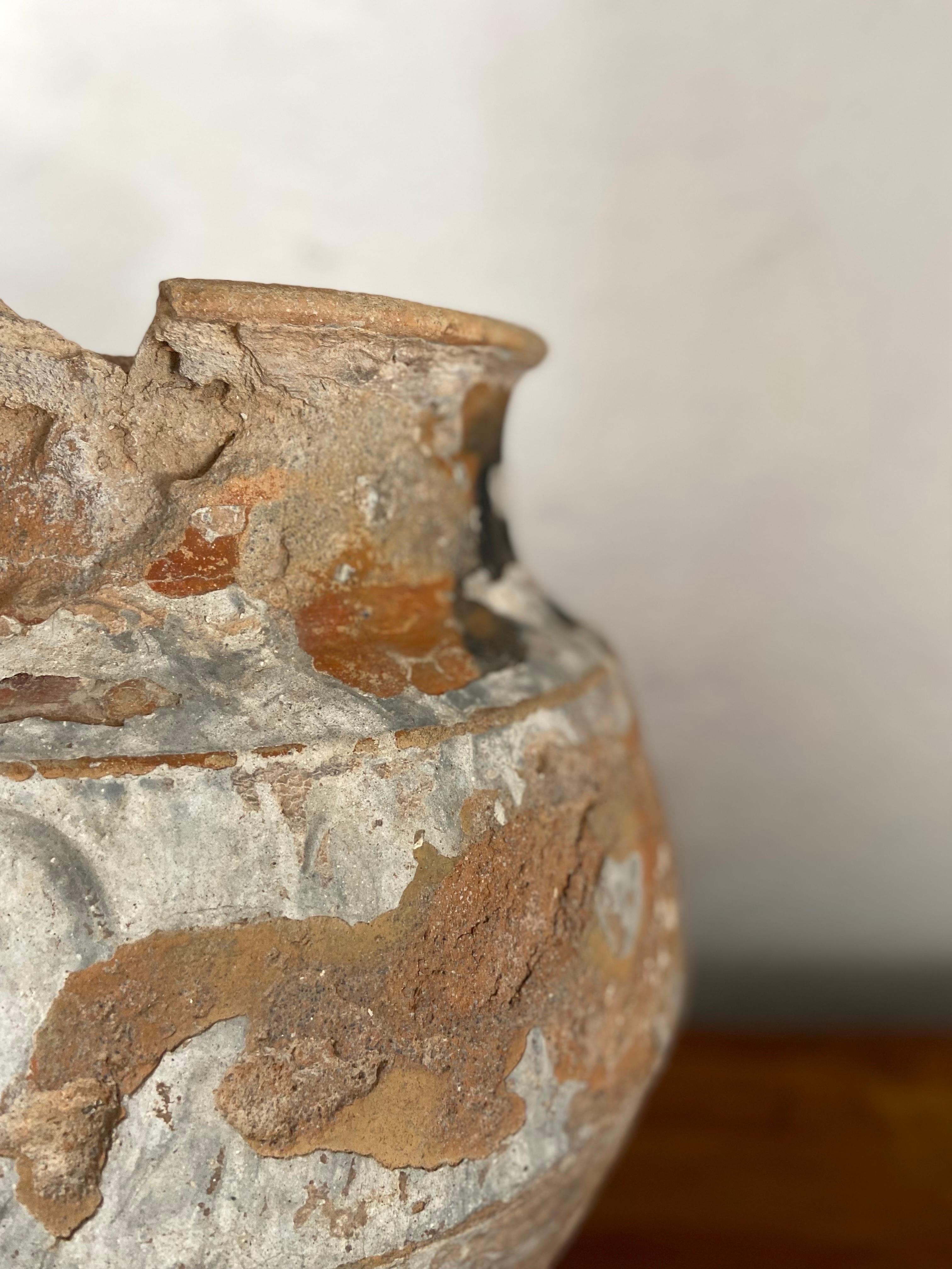 Highly distressed water jar from Central Yucatan, circa early 20th century. Bits of cement are evident on the vessel.