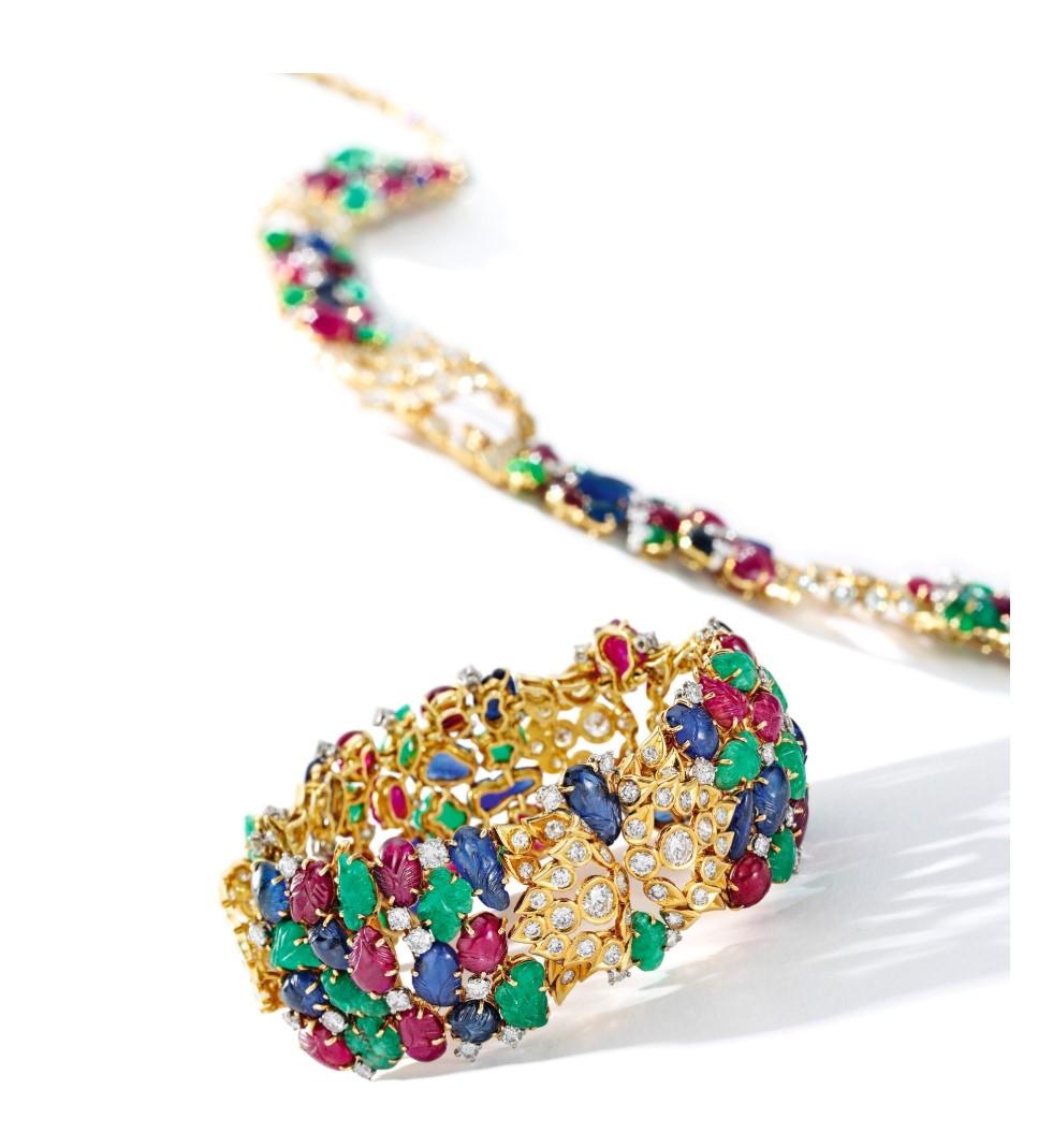 A Museum Quality Cartier Tutti Frutti Bracelet and Necklace Set

A very rare and iconic example of Cartier's greatest motif in a wide bracelet and a necklace.

French hallmarks, signed Cartier, and serial numbered.

Provenance:
Featured in The Book
