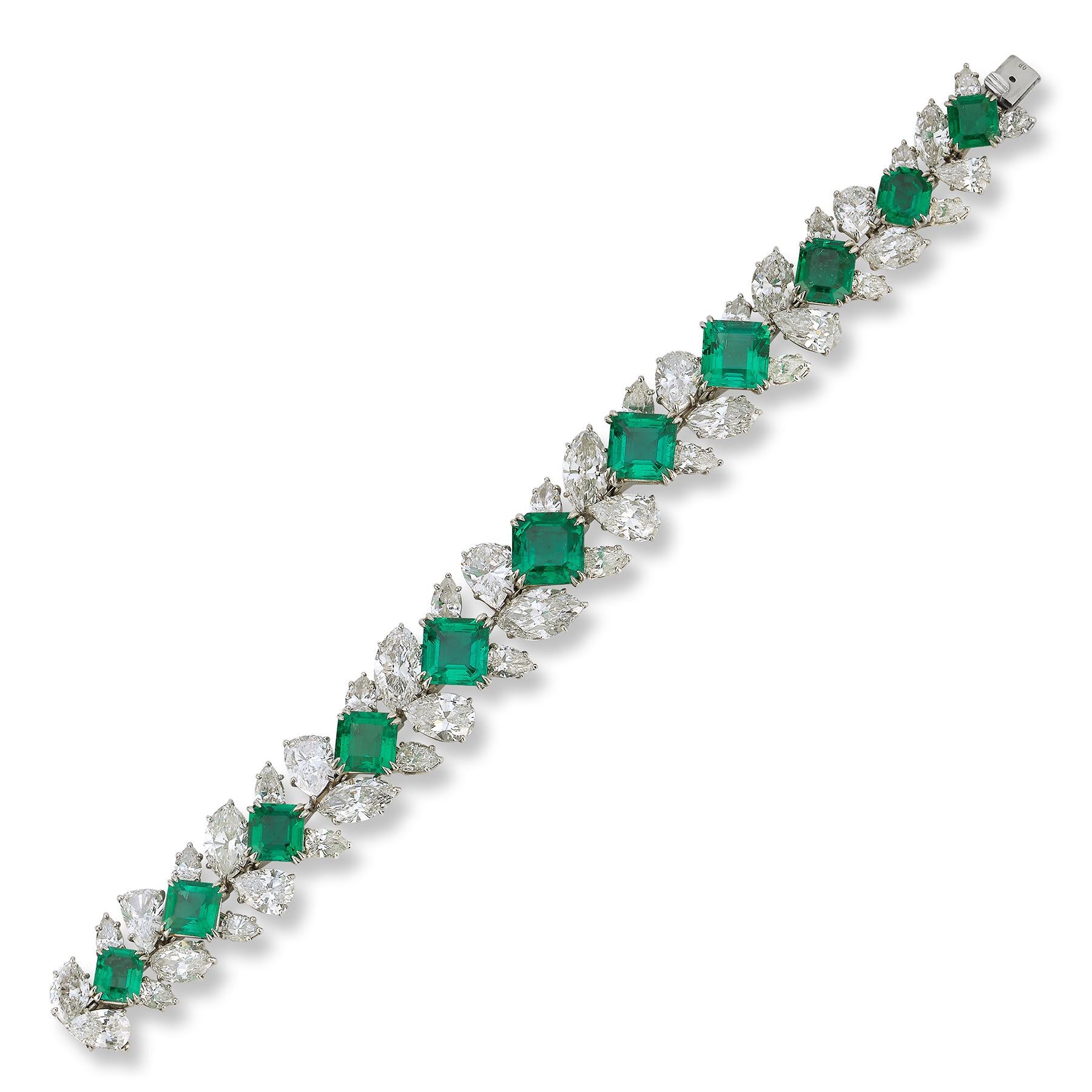 Highly Important Emerald and Diamond Bracelet by Harry Winston,

Featuring a row of  11 square emerald & emerald-cut emeralds, accented by pear- and marquise-shaped diamonds.

Circa 1976

Emerald Weight: approximately 27.35 carats
Diamond Weight: