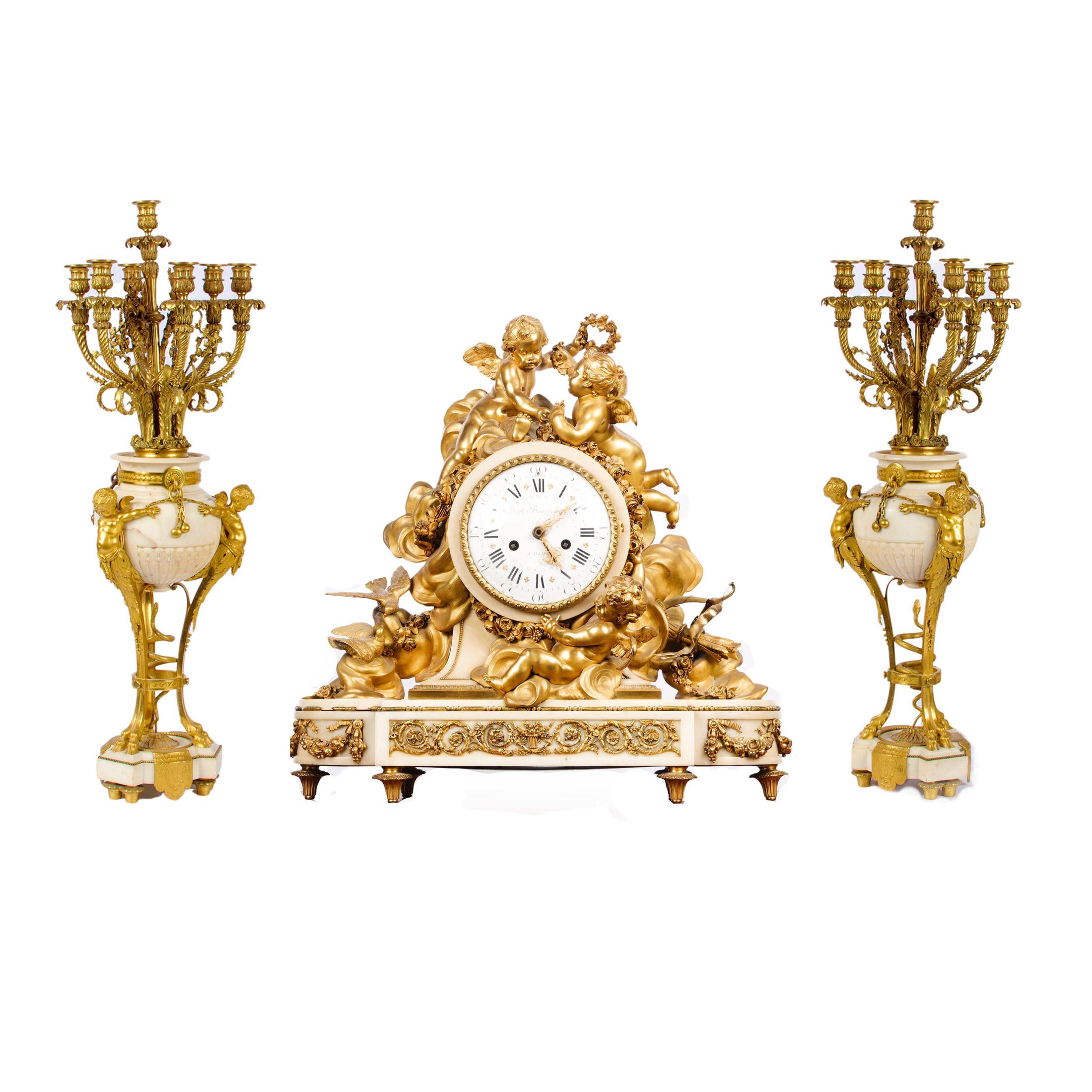 Highly Important Louis XVI style gilt bronze clockset by Beurdeley

A fine Louis XVI-style large gilt-bronze and white Rococo marble figural mantel clock is surmounted by three dore bronze putti figures hanging floral swag adornments among clouds