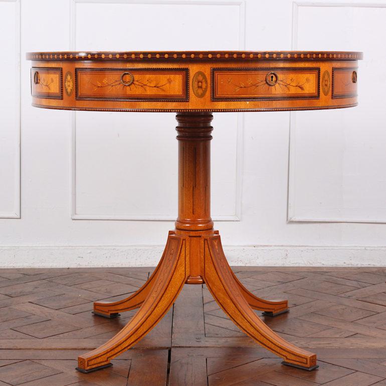 Highly inlaid satinwood drum table of exceptional quality inlaid throughout with purpleheart, boxwood, mahogany etc. The revolving top features four drawers and four false drawers, all with dramatic contrasting trimmed edges. The top has a hardwood