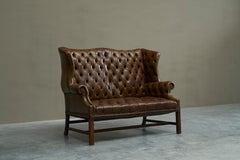 Highly Original Tufted English Wingback Settee in Patinated Leather 1900