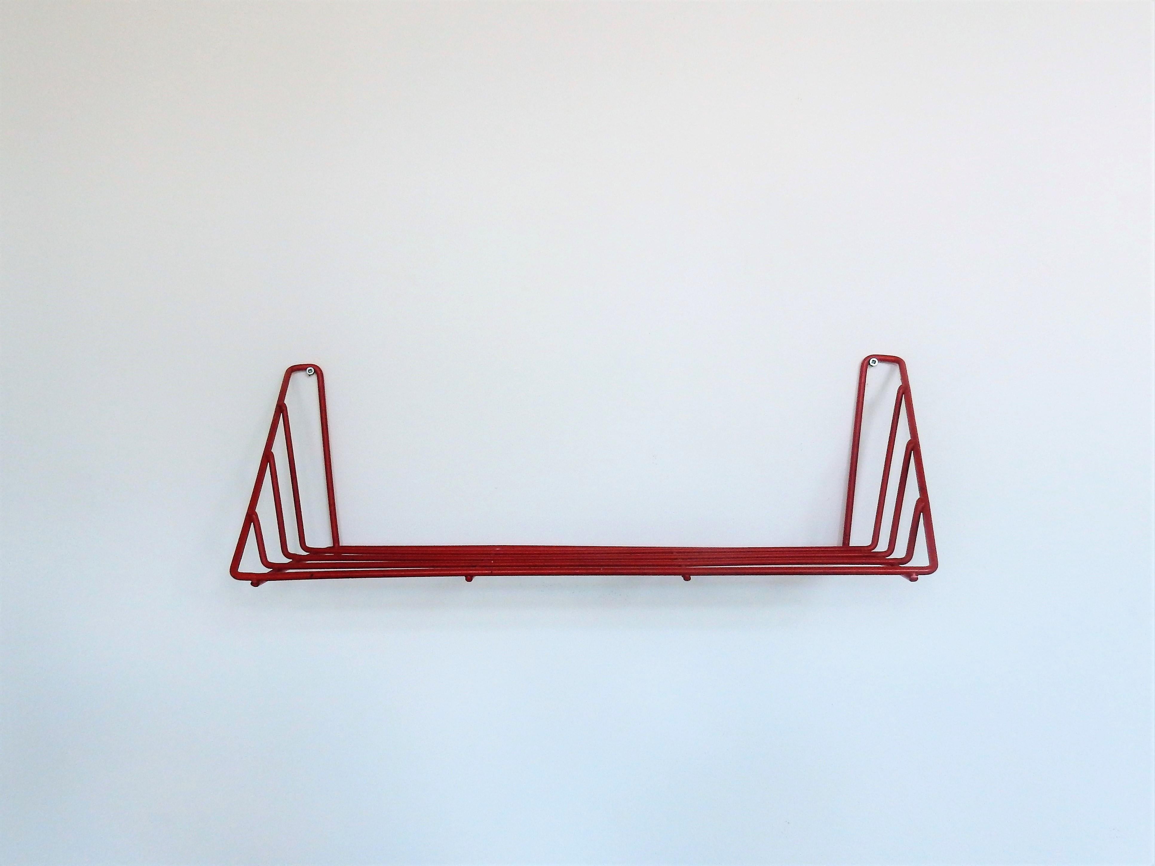 This shelf, called 'Delft' is a design by Constant Nieuwenhuys. Nieuwenhuys was a member of the CoBrA movement. He is known as a fine artist, musician, writer and he was also known for his visionary architectural work, known as 'New